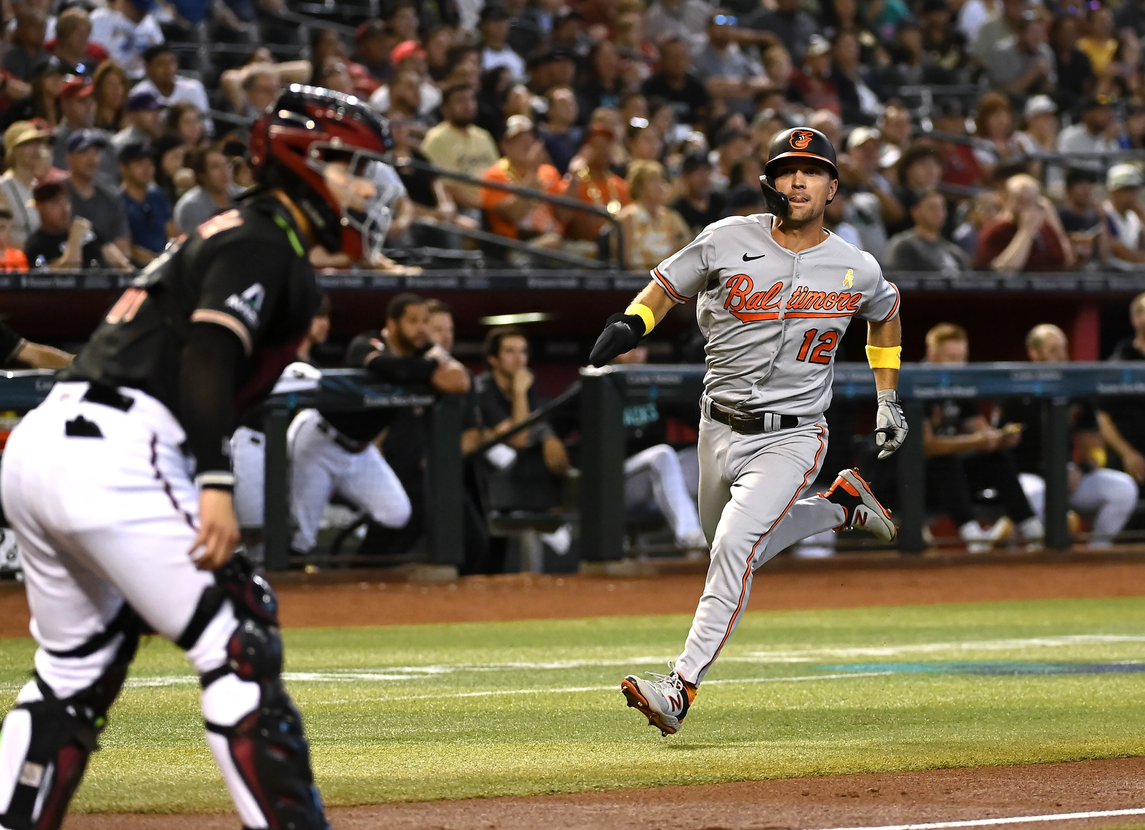 PHOENIX, ARIZONA - SEPTEMBER 03: Adam Frazier #12 of the Baltimore Orioles scores on a single by Gunnar Henderson #2 against the Arizona Diamondbacks during the second inning at Chase Field on September 03, 2023 in Phoenix, Arizona. (Photo by Norm Hall/Getty Images)