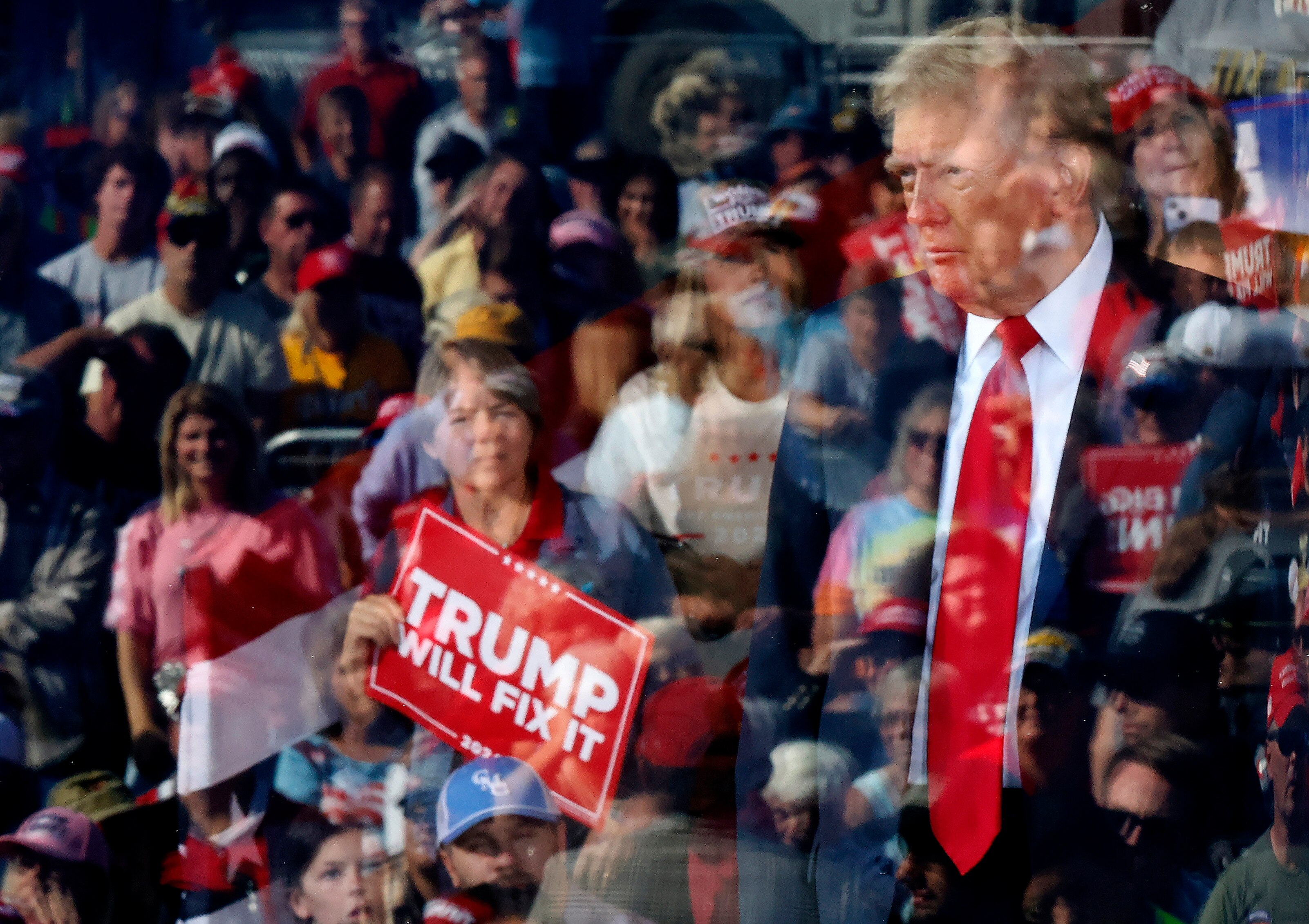 GASTONIA, NORTH CAROLINA - NOVEMBER 02: Republican presidential nominee, former President Donald Trump is seen through protective bullet-resistant glass where his supporters are reflected during a campaign rally at Gastonia Municipal Airport on November 02, 2024 in Gastonia, North Carolina. With three days until the election, Trump is campaigning for re-election in the battleground state of North Carolina, where recent polls have the former president and his opponent, Democratic nominee, Vice President Kamala Harris in a dead heat.