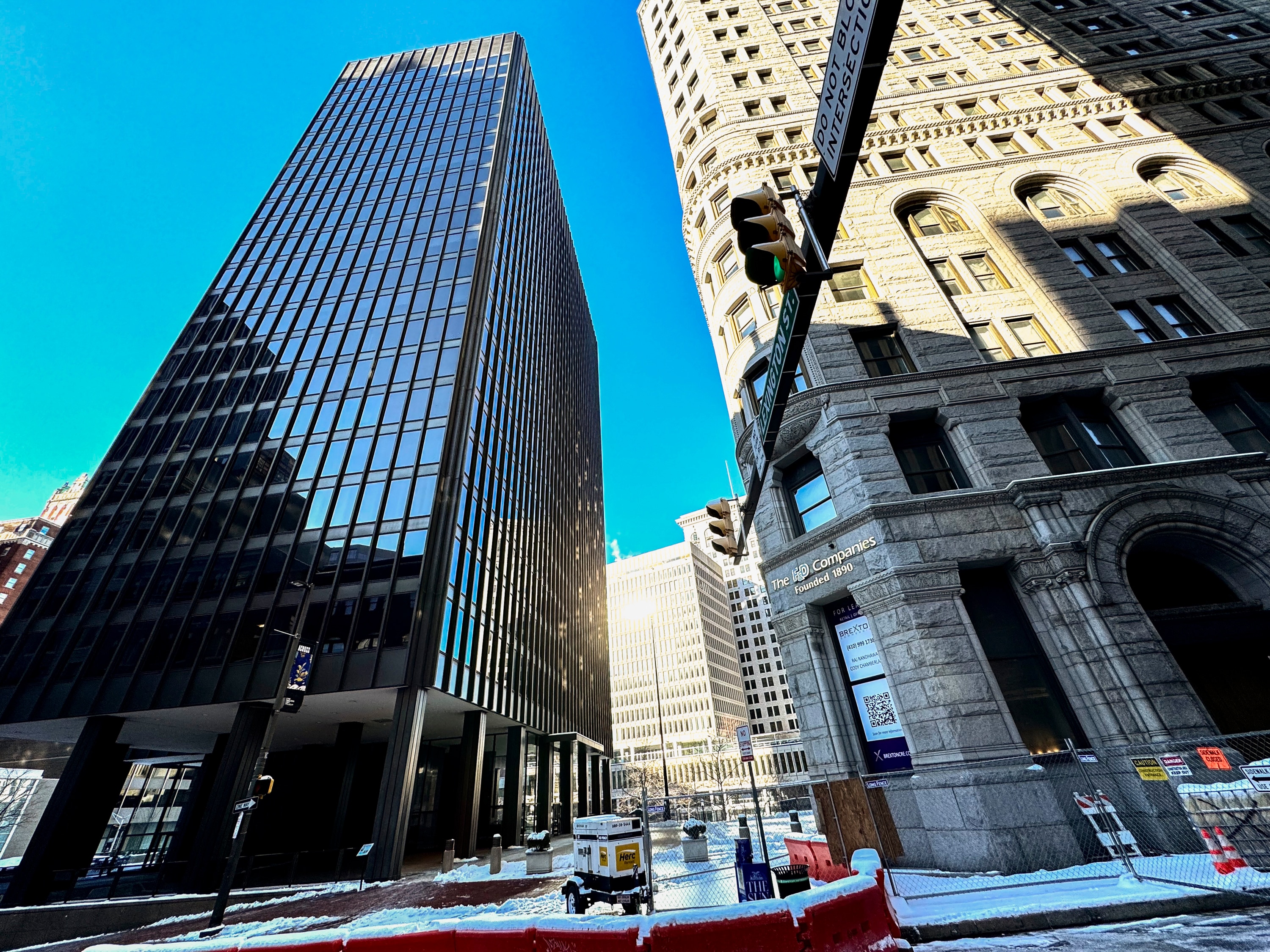 A downtown office building owned by Peter Angelos, left, owes a sizable water bill. The building, however, is mostly vacant. The owner of the tower next door, right, says his basement is flooding with 10 gallons of water every minute. There could be a large water leak in downtown Baltimore.