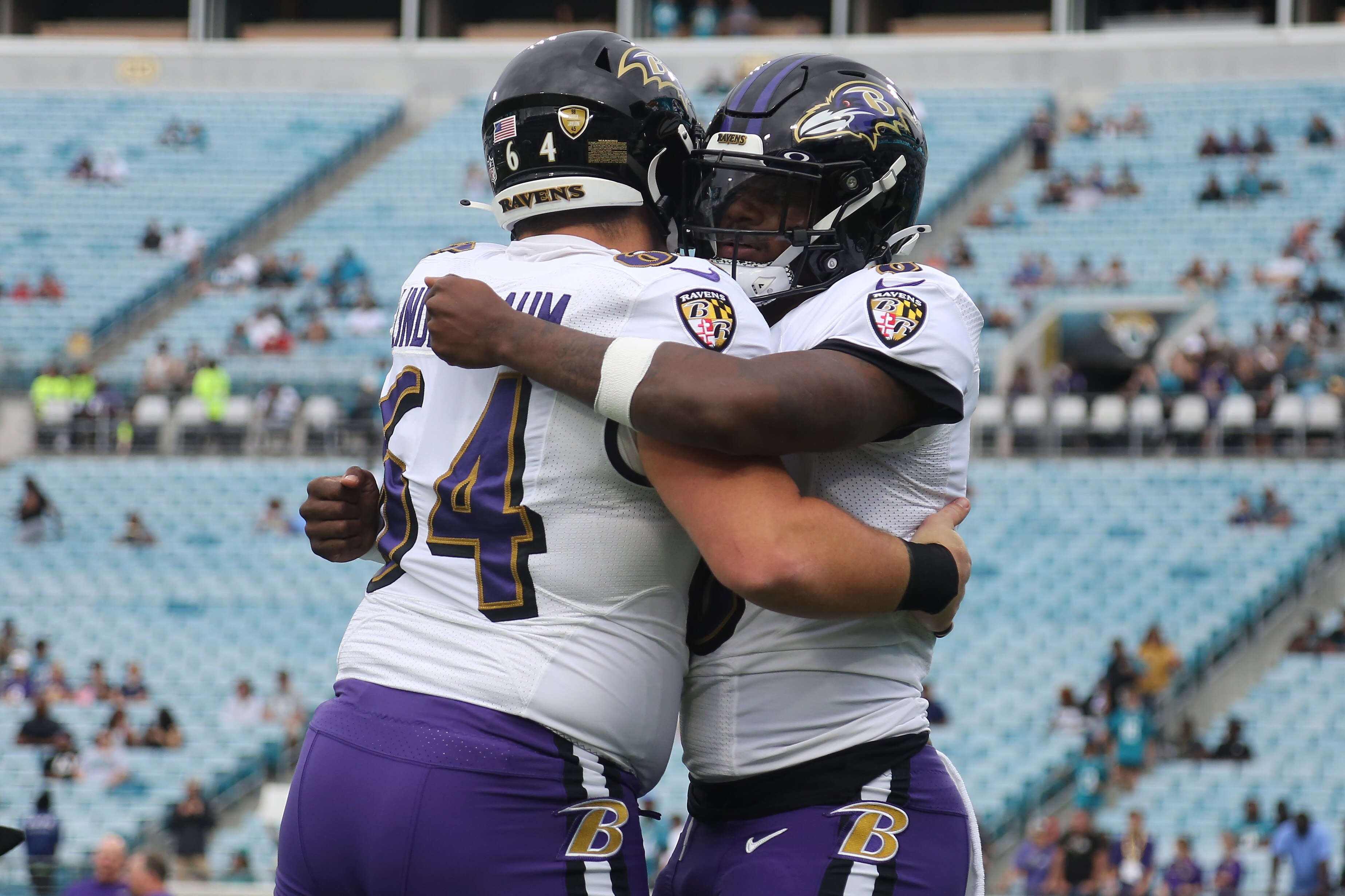 Lamar Jackson #8 and Tyler Linderbaum #64 of the Baltimore Ravens embrace before the game against the Jacksonville Jaguars at TIAA Bank Field on November 27, 2022 in Jacksonville, Florida.