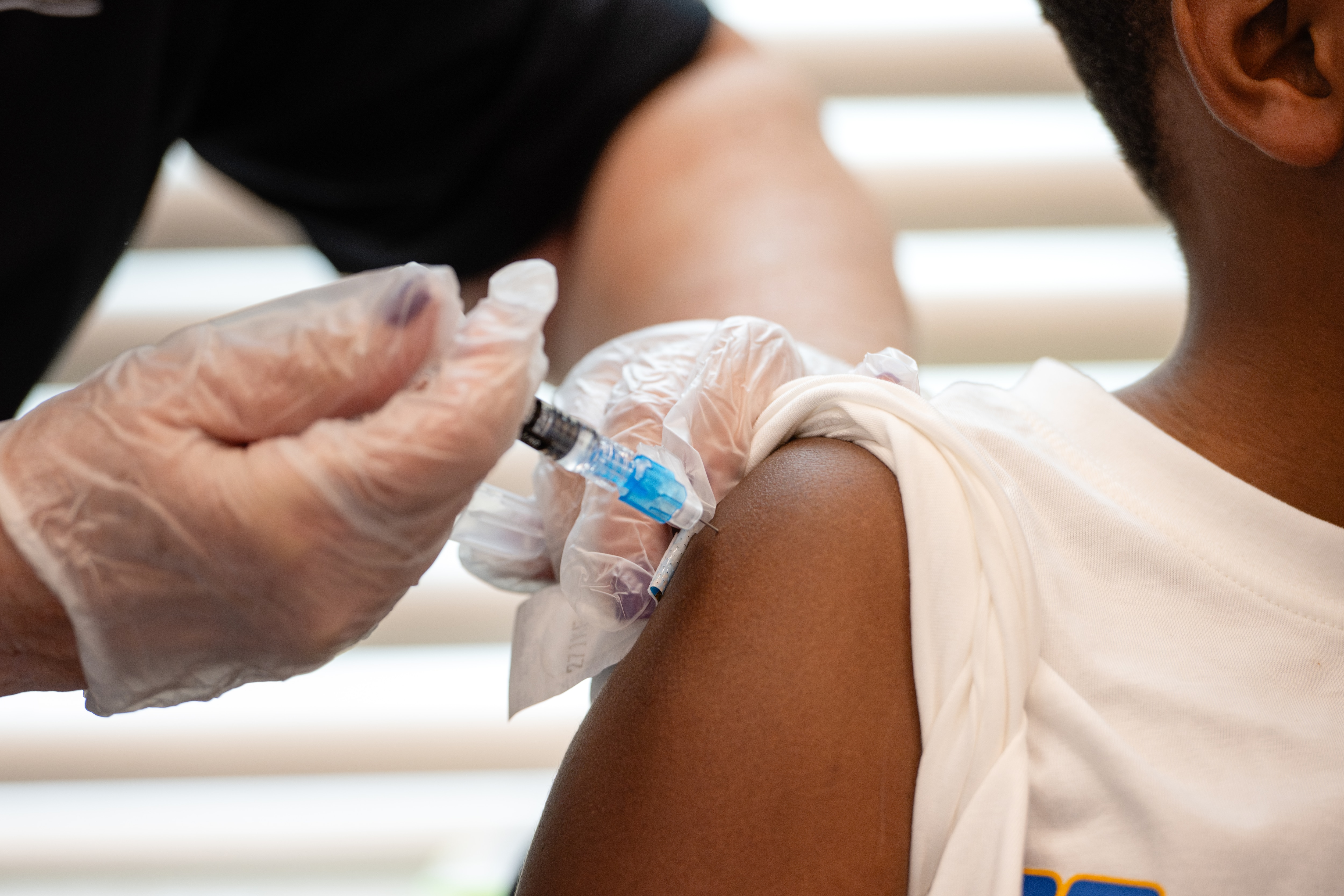 A student receives an injection during a Vaccine Clinic offered at BCPS Fest held at New Town High School on August 16th, 2025 in Owings Mills, MD.