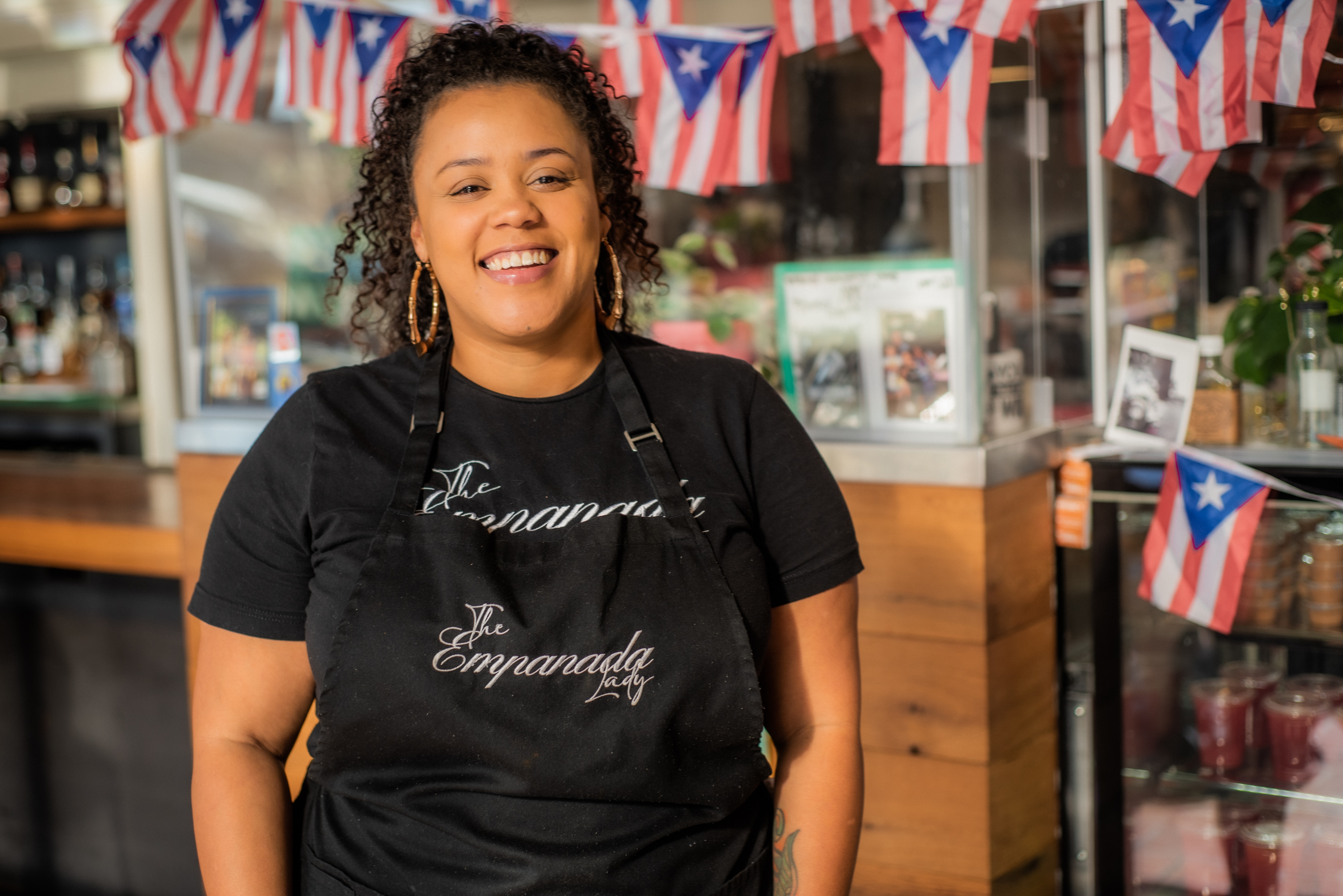 Elisa Milan, owner of the Empanada Lady, stands for a portrait inside her Baltimore store.