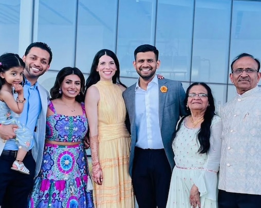 Audrey and Vikesh Patel pose with Vikesh's family on the night before their April 2024 wedding. From left is his niece, Mila, his sister, Dhanisha, his brother-in-law Bhavik, his mother, Ramila, and his father, Dipak.