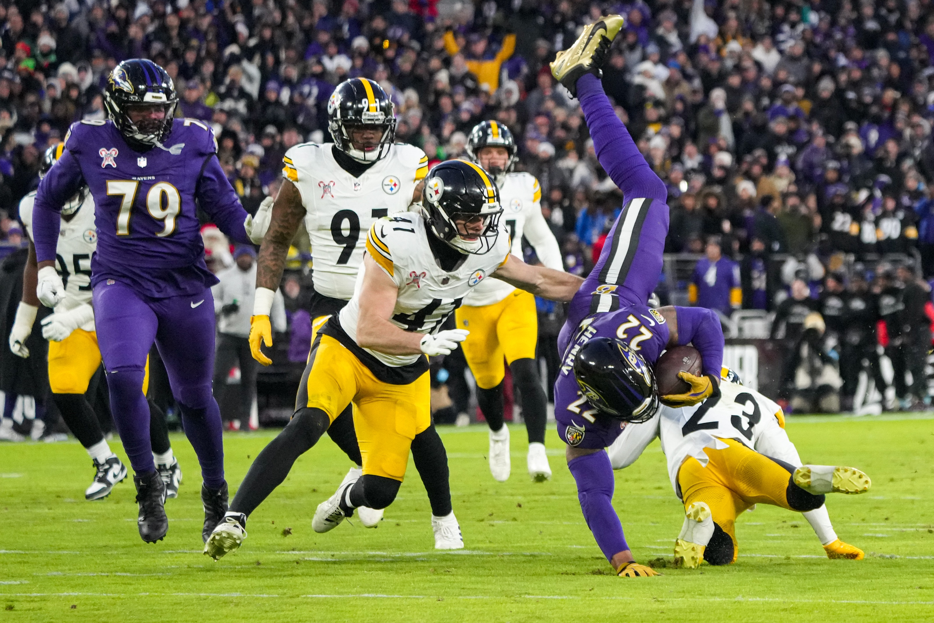 Running back Derrick Henry is upended during the Ravens’ home victory over the Steelers on Dec. 21.