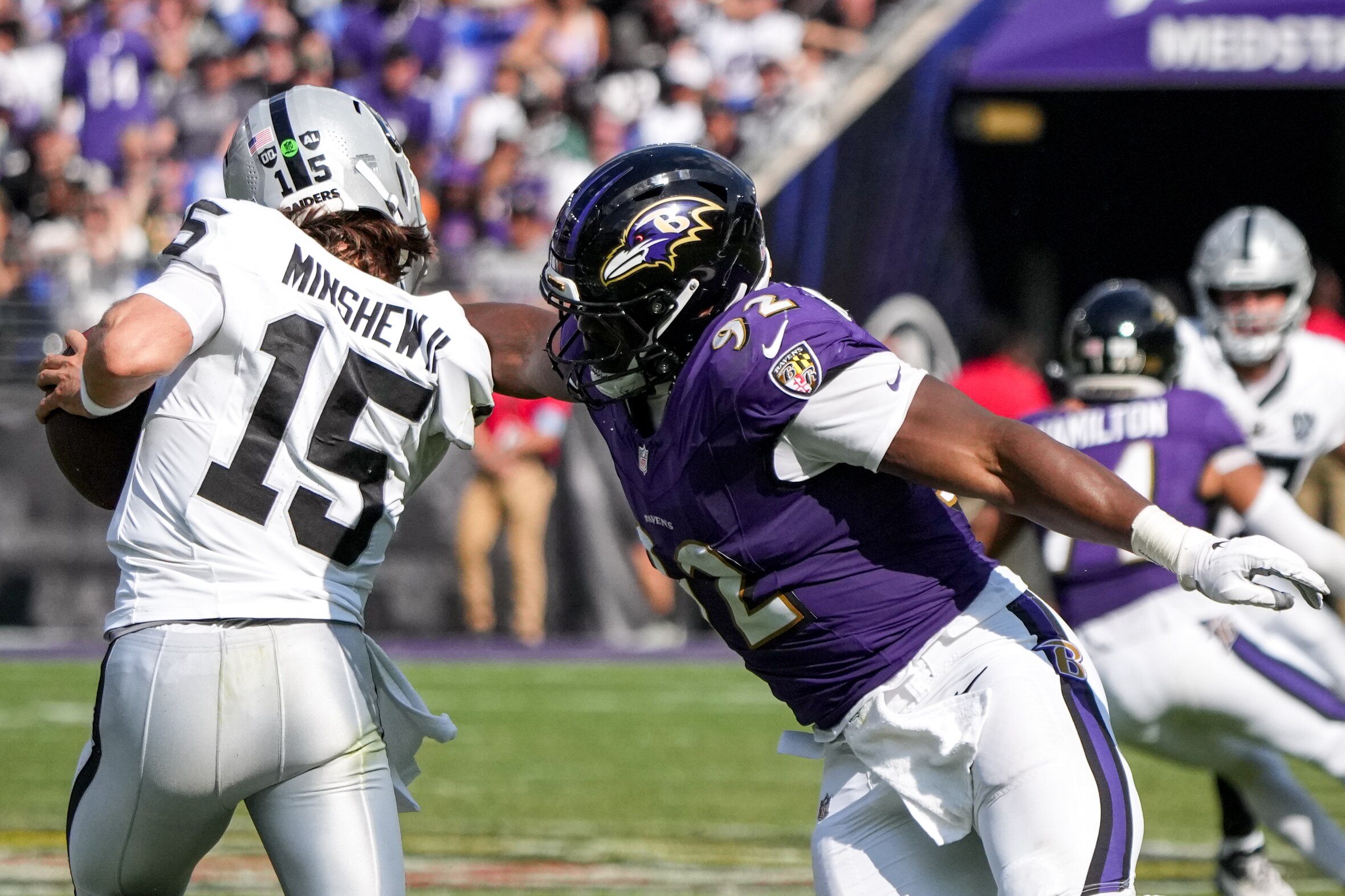 The Ravens’ Nnamdi Madubuike hits Raiders quarterback Gardner Minshew, drawing a penalty, during a game in 2024.
