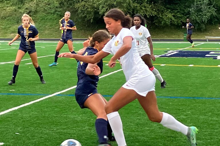 Hereford sophomore forward Aaliyah Stocks bolts up the sideline as Perry Hall senior midfielder Bridgette Asher defends in the 14th-ranked Gators’ 3-2 win on Tuesday.