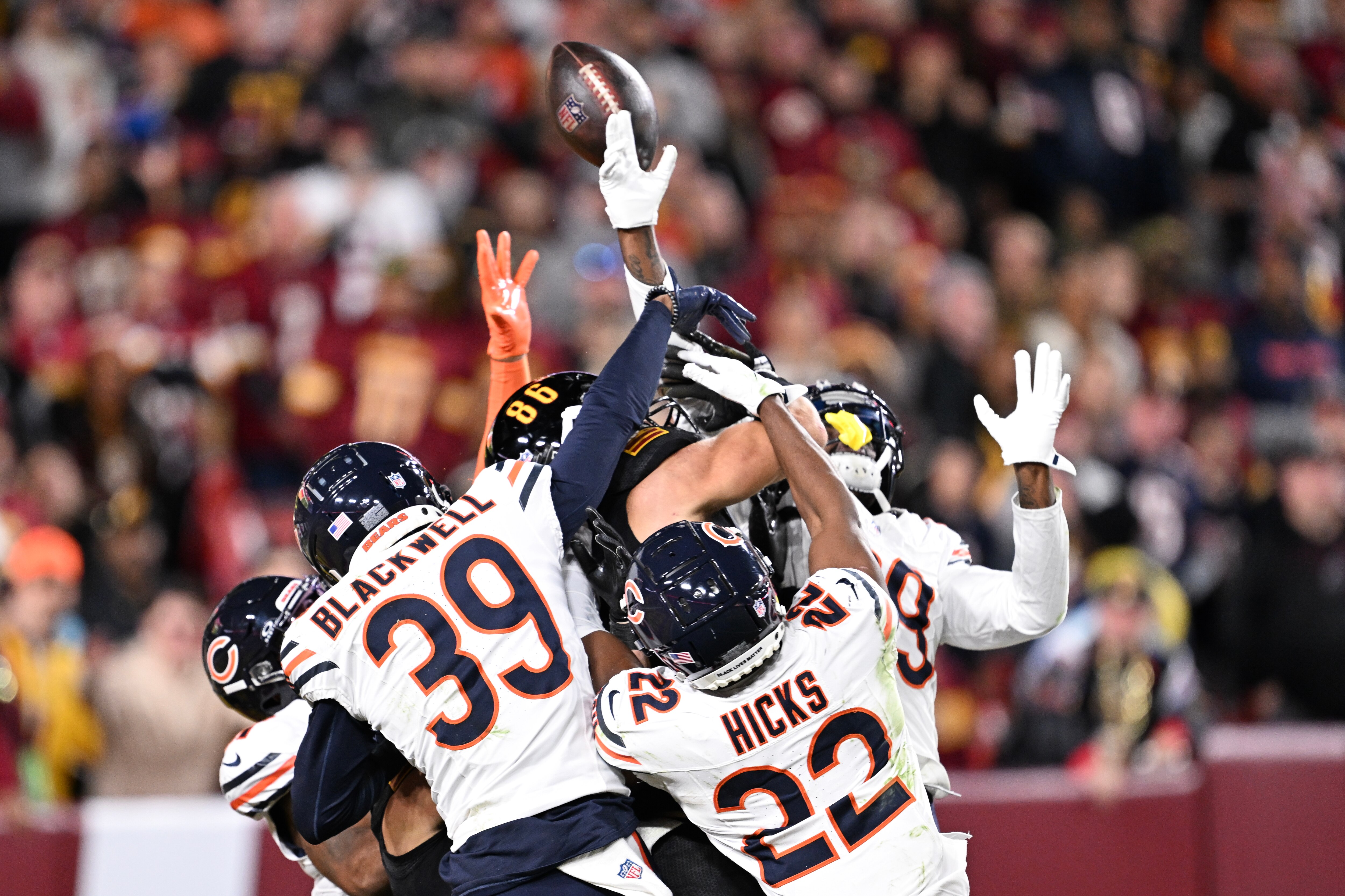 Bears defenders go after the ball that eventually landed in the arms of the Commanders’ Noah Brown last year in Washington’s 18-15 victory over Chicago.