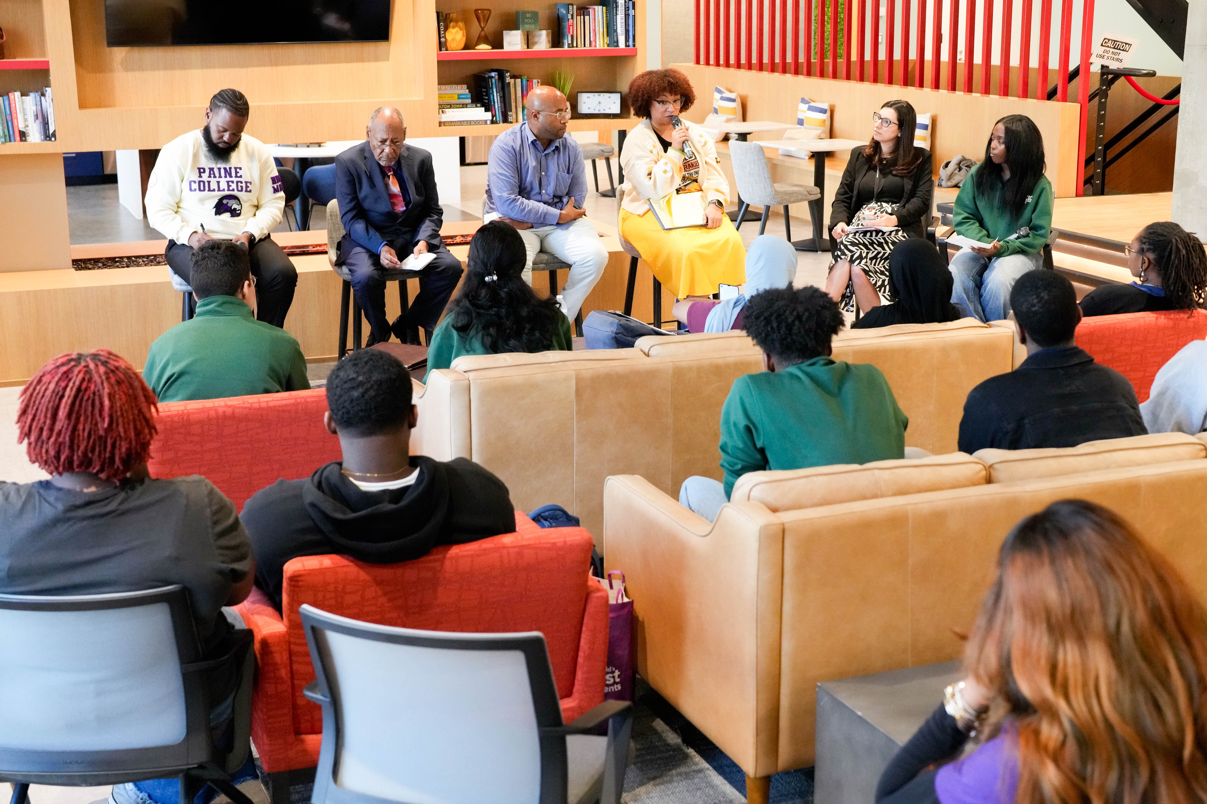 From left, Jamar Day, Commissioner Kwame’ Jamal Kenyatta-Bey, Domonique Flowers and Commissioner Ashley Esposito take turns giving remarks during a forum for Baltimore school board candidates at Spark Flex, adjacent to The Banner offices, on Monday.