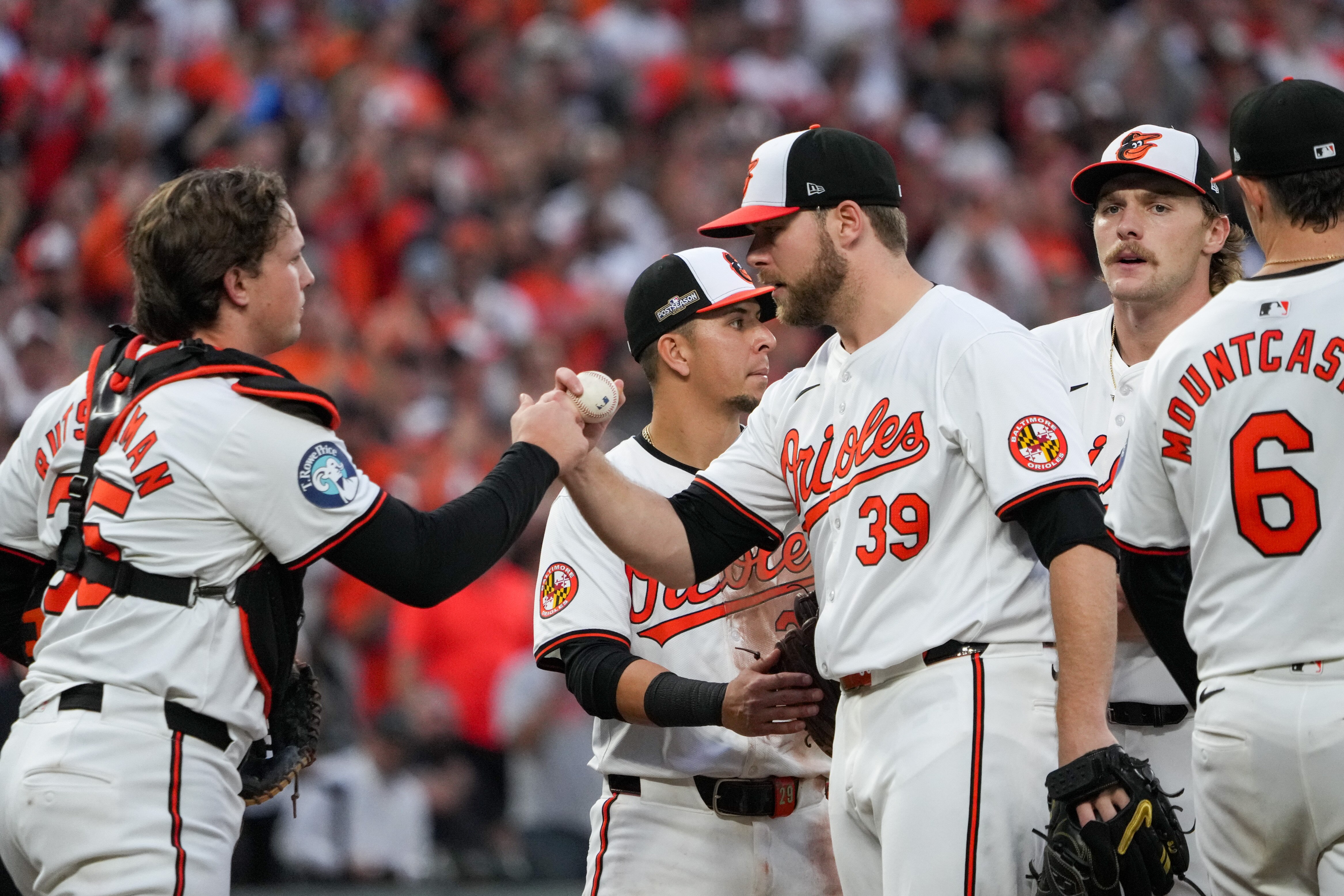 Baltimore Orioles pitcher Corbin Burnes (39) fist bumps catcher Adley Rutschman (35) as he’s pulled from the game after eight innings during the first game of the wild-card playoff round against the Kansas City Royals at Camden Yards in Baltimore on Tuesday, Oct. 1, 2024.