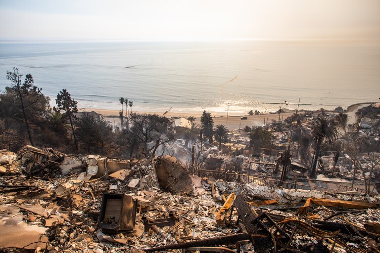 Burned houses are seen from the Palisades Fire on January 9, 2025 in the Pacific Palisades neighborhood of Los Angeles, California.