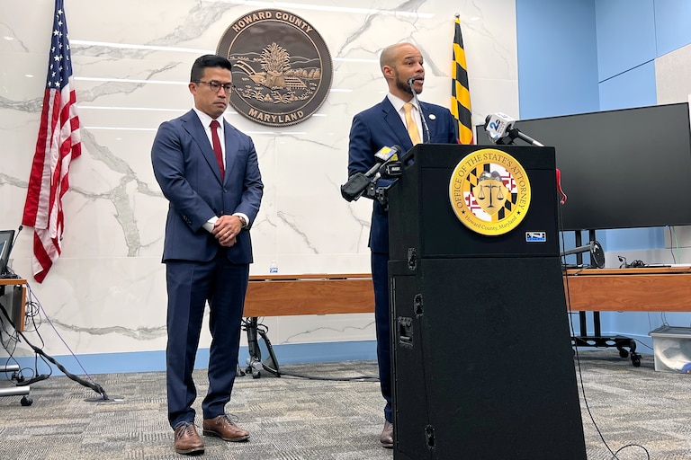 Howard County State’s Attorney Rich Gibson Jr., right, speaks after a man was sentenced to life in prison without the possibility of parole plus 70 years in the fatal shootings of two teens near The Mall in Columbia in 2025. Senior Assistant State's Attorney Dillon Yeung is at left.
