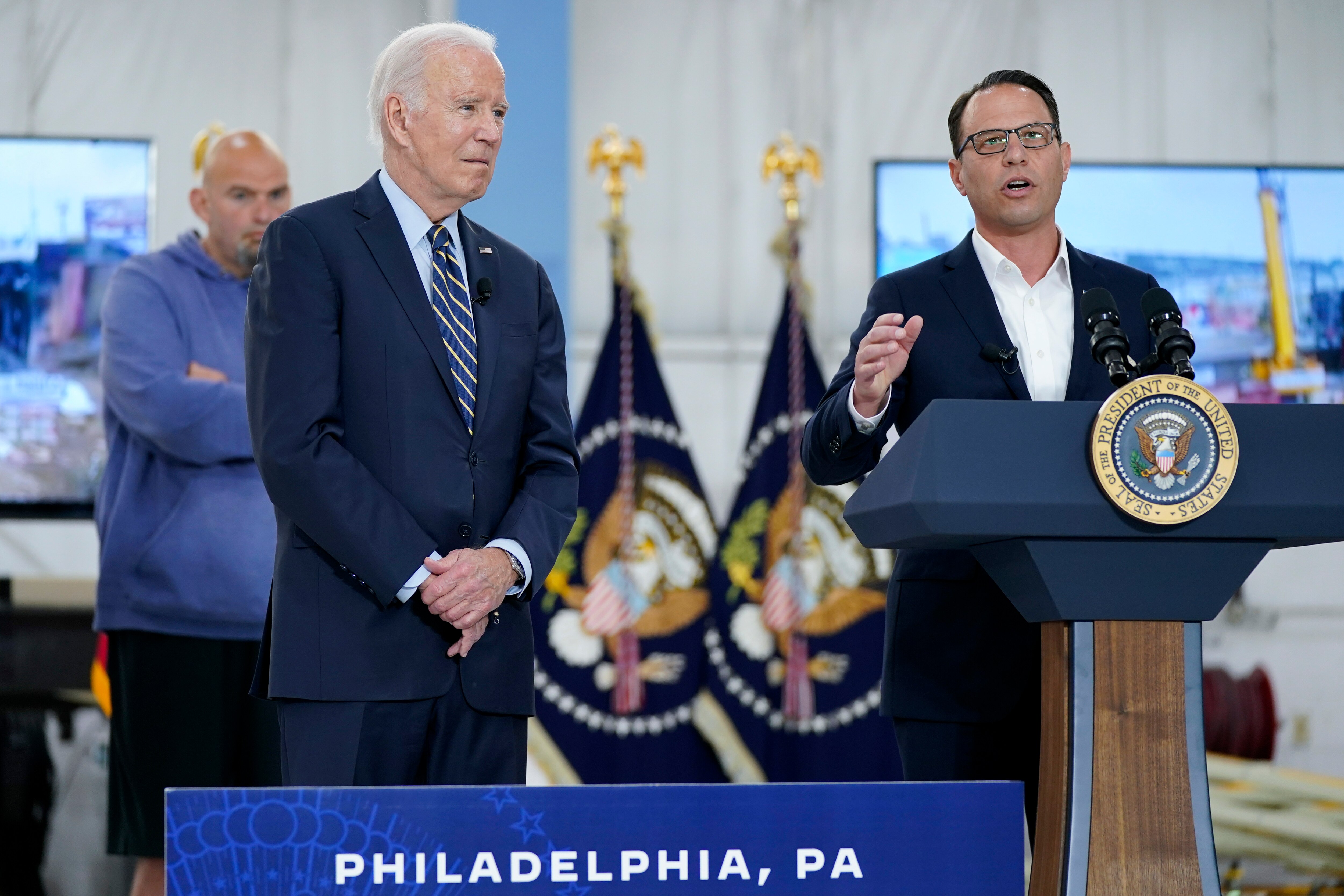President Joe Biden listens as Pennsylvania Gov. Josh Shapiro speaks at the Philadelphia International Airport in Philadelphia, Saturday, June 17, 2023, after an aerial tour of the Interstate 95 highway collapse.