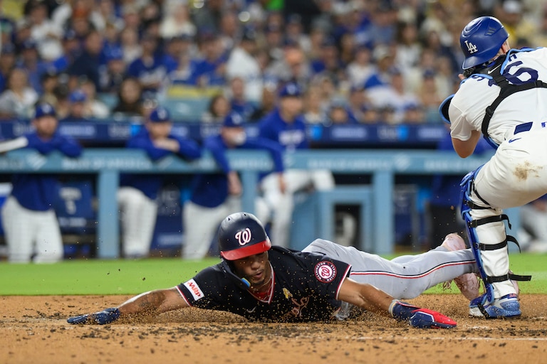 Washington Nationals' Daylen Lile, left, slides to score past Los Angeles Dodgers catcher Will Smith on a two-run double by Harry Ford during the fourth inning of a baseball game in Los Angeles, Sunday, Sept. 6, 2026.