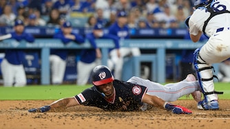 Washington Nationals' Daylen Lile, left, slides to score past Los Angeles Dodgers catcher Will Smith on a two-run double by Harry Ford during the fourth inning of a baseball game in Los Angeles, Sunday, Sept. 6, 2026.