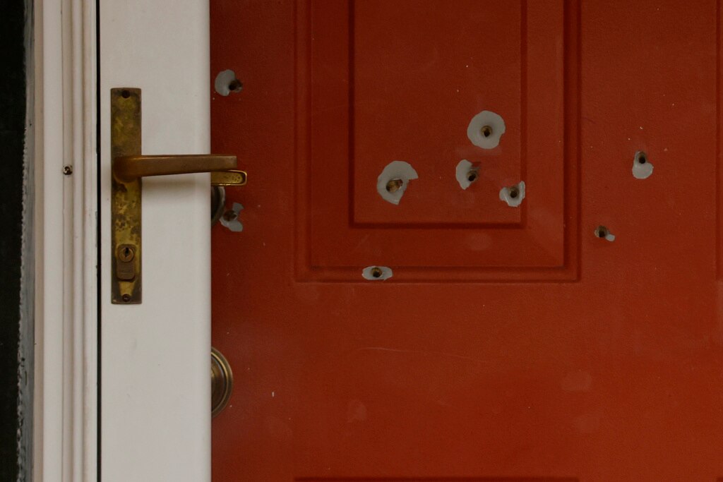 Bullet holes mark the front door of the house of Minnesota state Sen. John Hoffman and his wife who were shot earlier in the day.