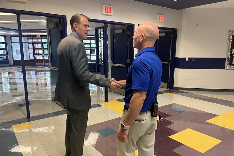 Superintendent Thomas Taylor shakes hands with John Poole Middle School principal Jon Green after touring his campus.