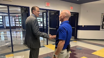 Superintendent Thomas Taylor shakes hands with John Poole Middle School principal Jon Green after touring his campus.