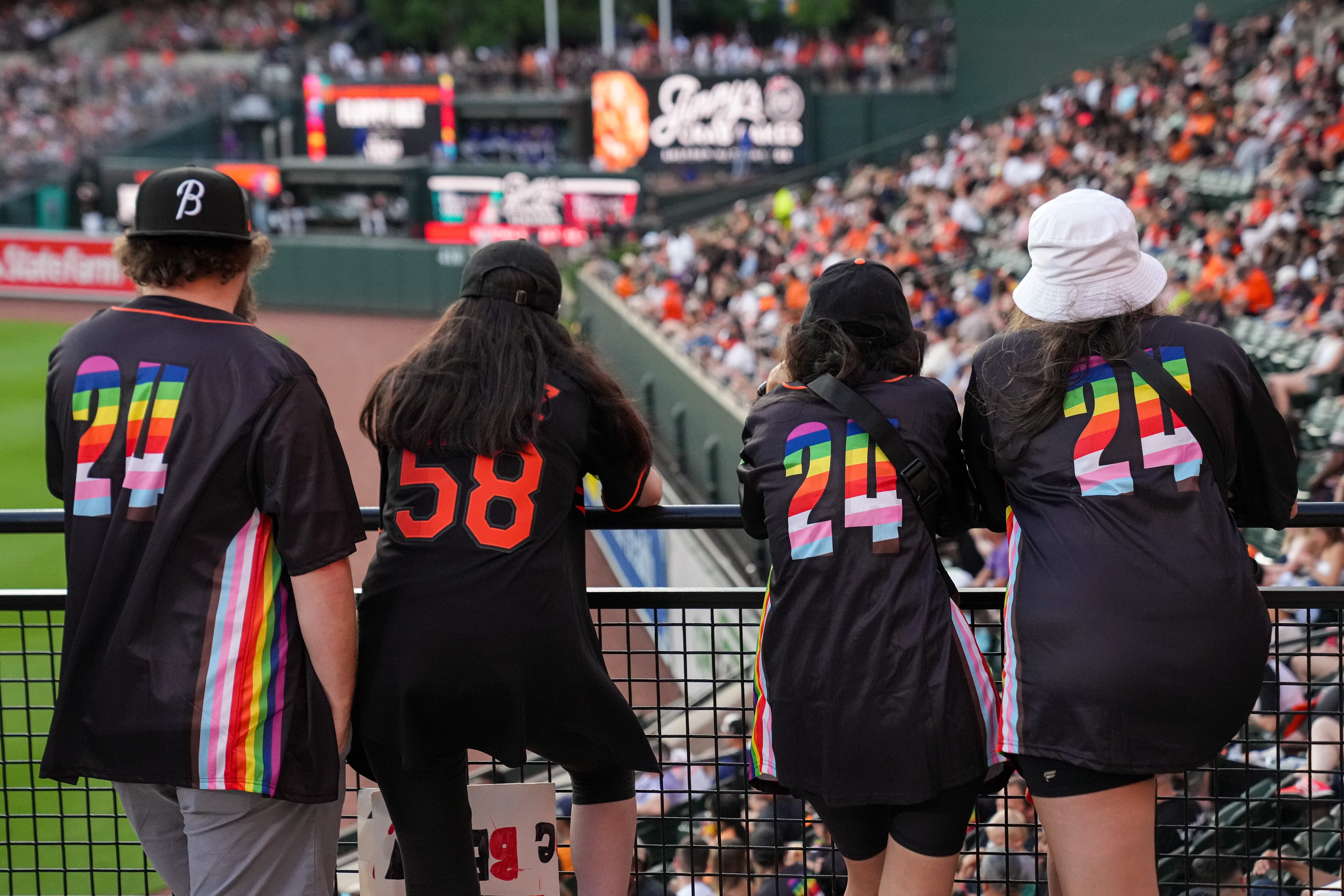 A group of friends wearing the Orioles Pride Night jerseys watch the 11-2 win over the Texas Rangers Thursday night at Camden Yards.