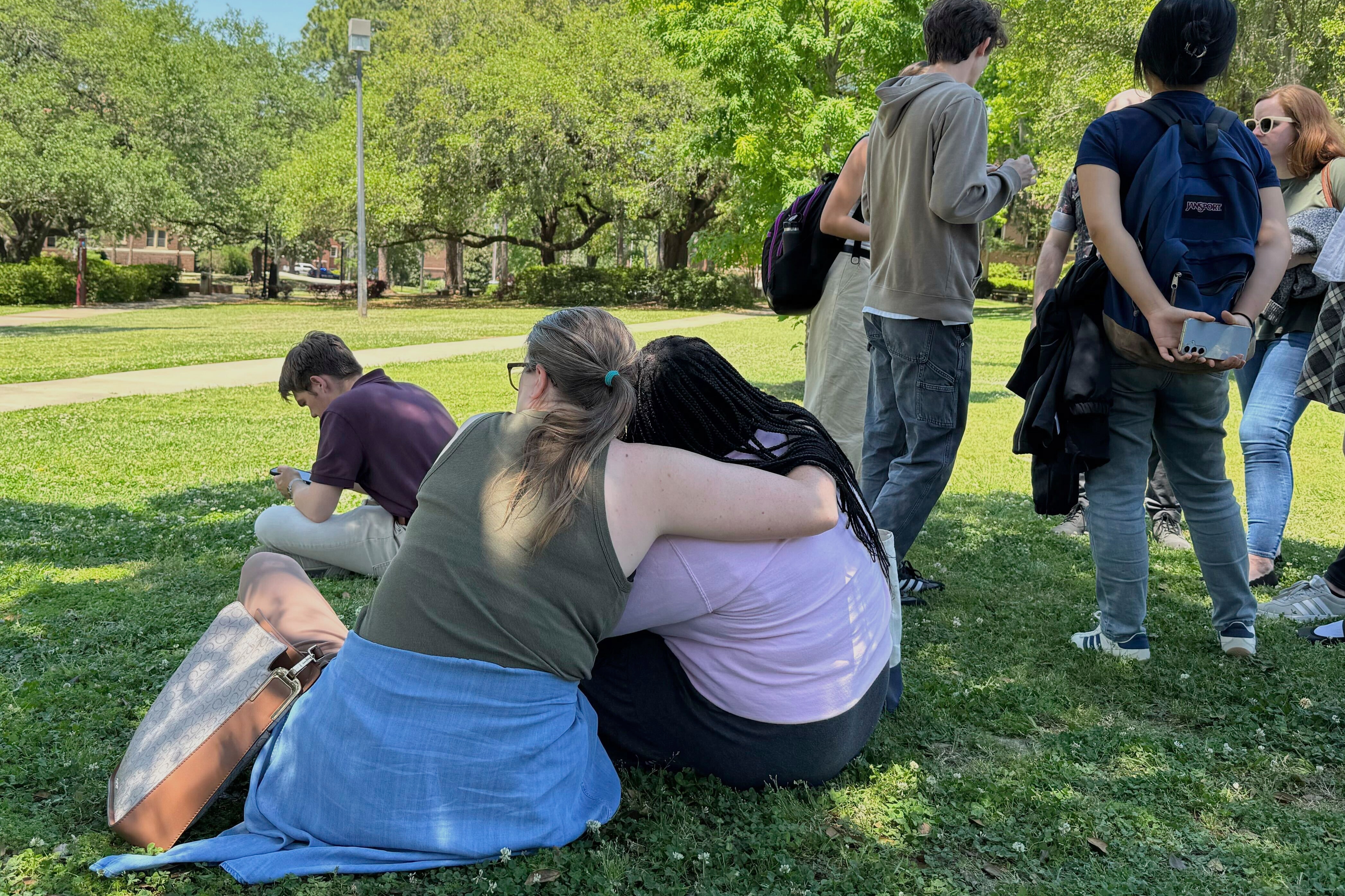 People comfort each other on Florida State University’s campus in Tallahassee, where law enforcement responded to a reported active shooter incident Thursday, April 17, 2025.