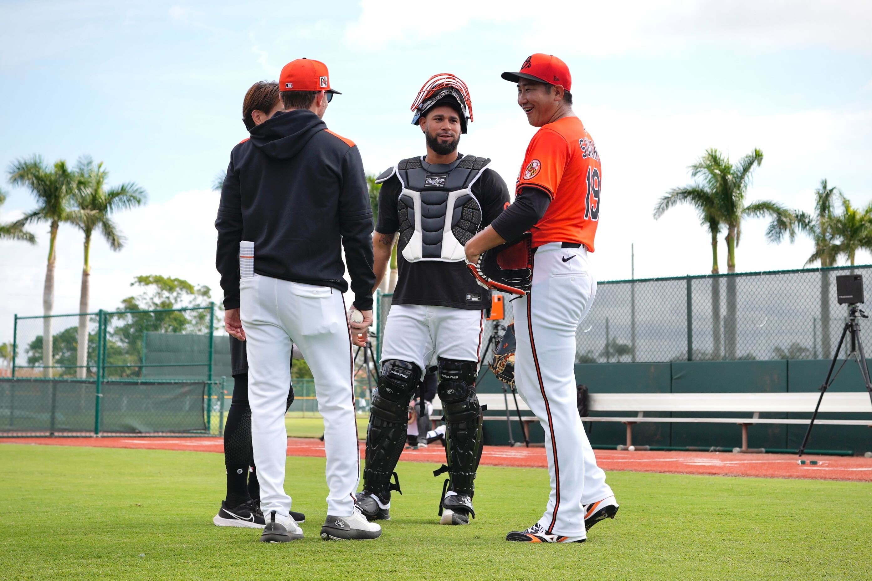 Orioles right-hander Tomoyuki Sugano debriefs his first bullpen of spring training with pitching coach Drew French, catcher Gary Sánchez and interpreter Yuto Sakurai on Tuesday, Feb. 18, 2025, at the Ed Smith Stadium complex in Sarasota, Florida.