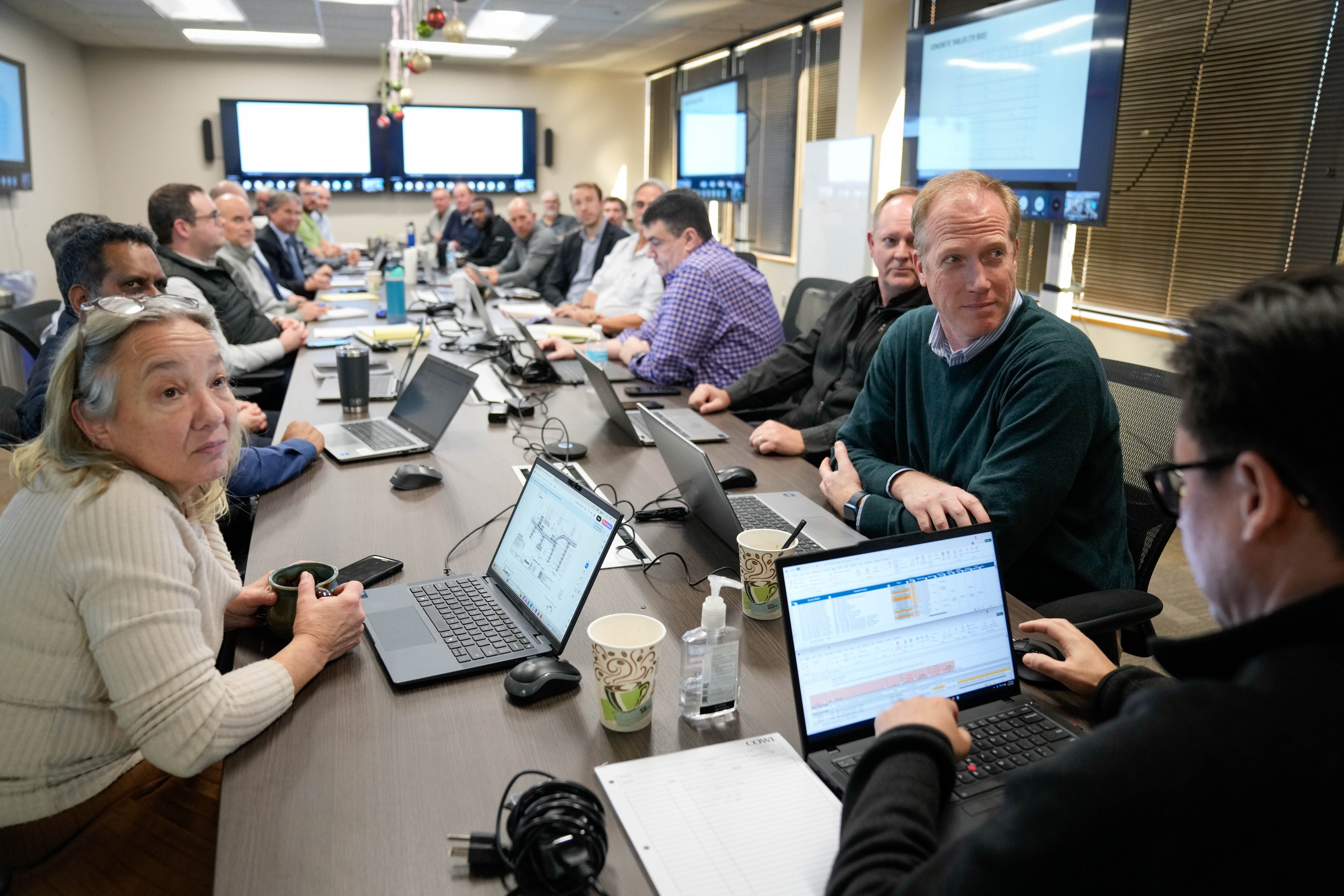Employees hold a team meeting in an office at an Anne Arundel County business park where engineers work on the design for the new Francis Scott Key Bridge project.
