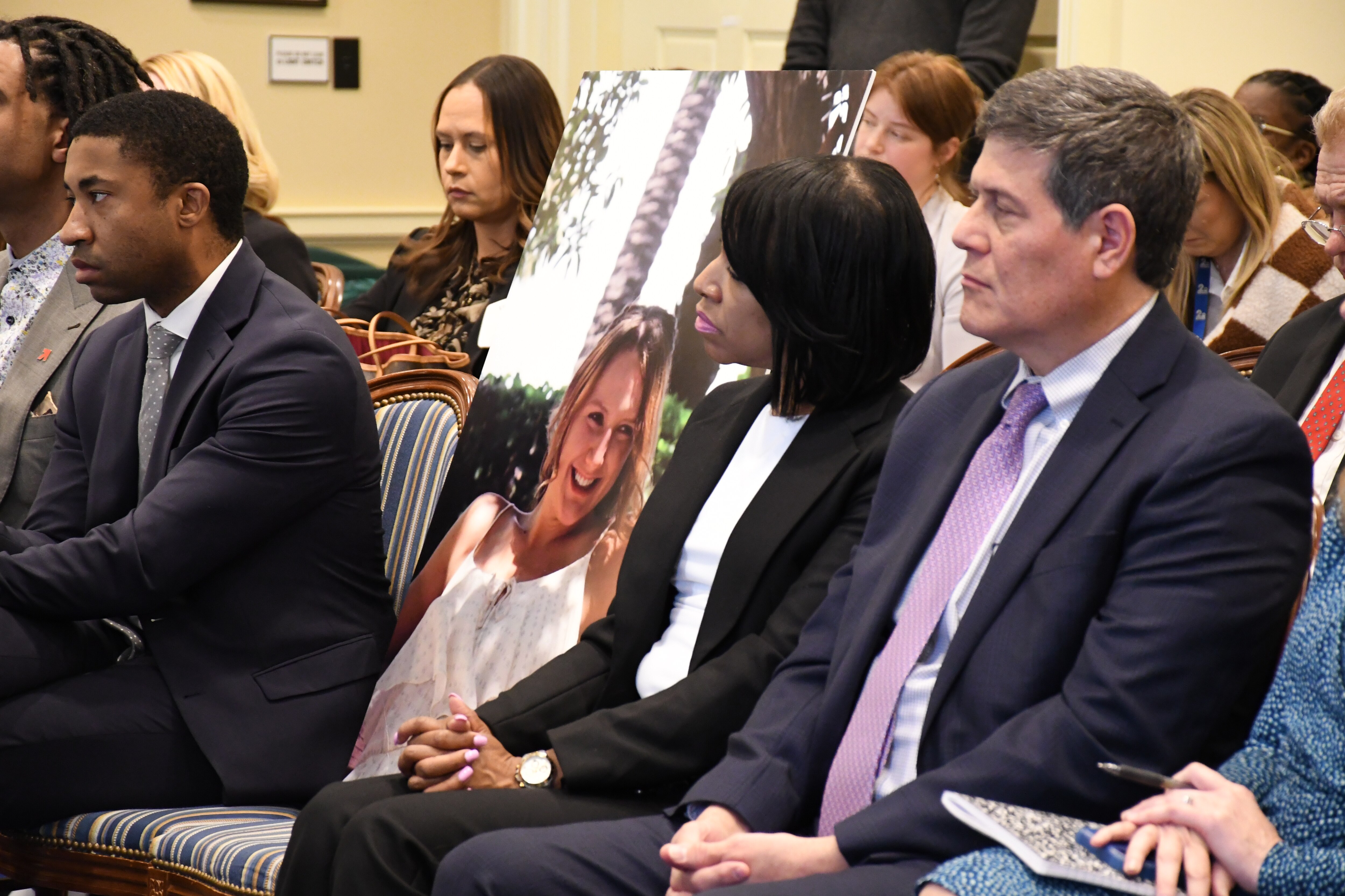 A poster of the late Pava Marie LaPere is propped on a chair in the Maryland House of Delegates Judiciary Committee room on Feb. 6, 2024 during a hearing on the Pava Marie LaPere Act.