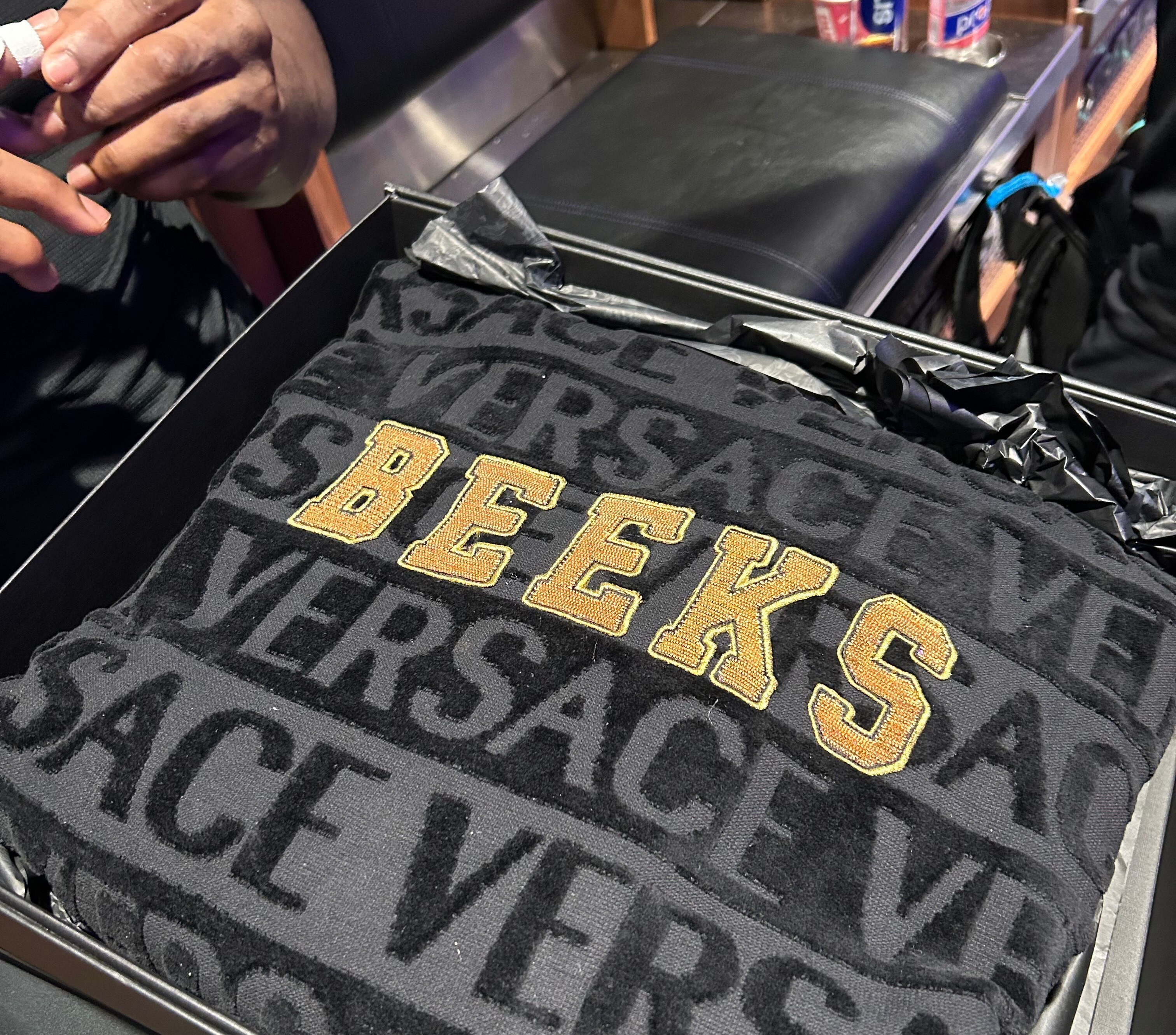 Ravens defensive tackle Justin Madubuike's customized Versace robe, courtesy of middle linebacker Roquan Smith.