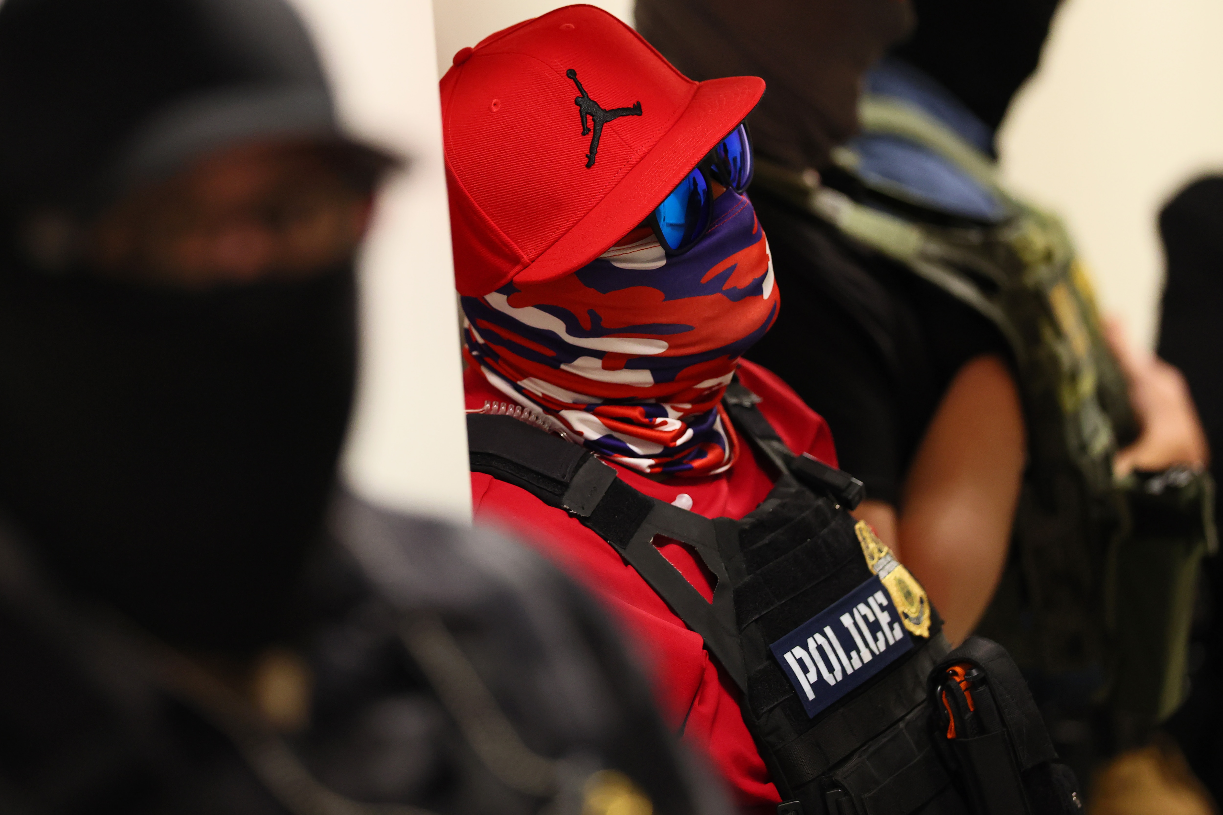 Under a law that took effect Oct. 1, law enforcement officers in Maryland could face civil penalties and fines for wearing face coverings like this federal agent in New York.