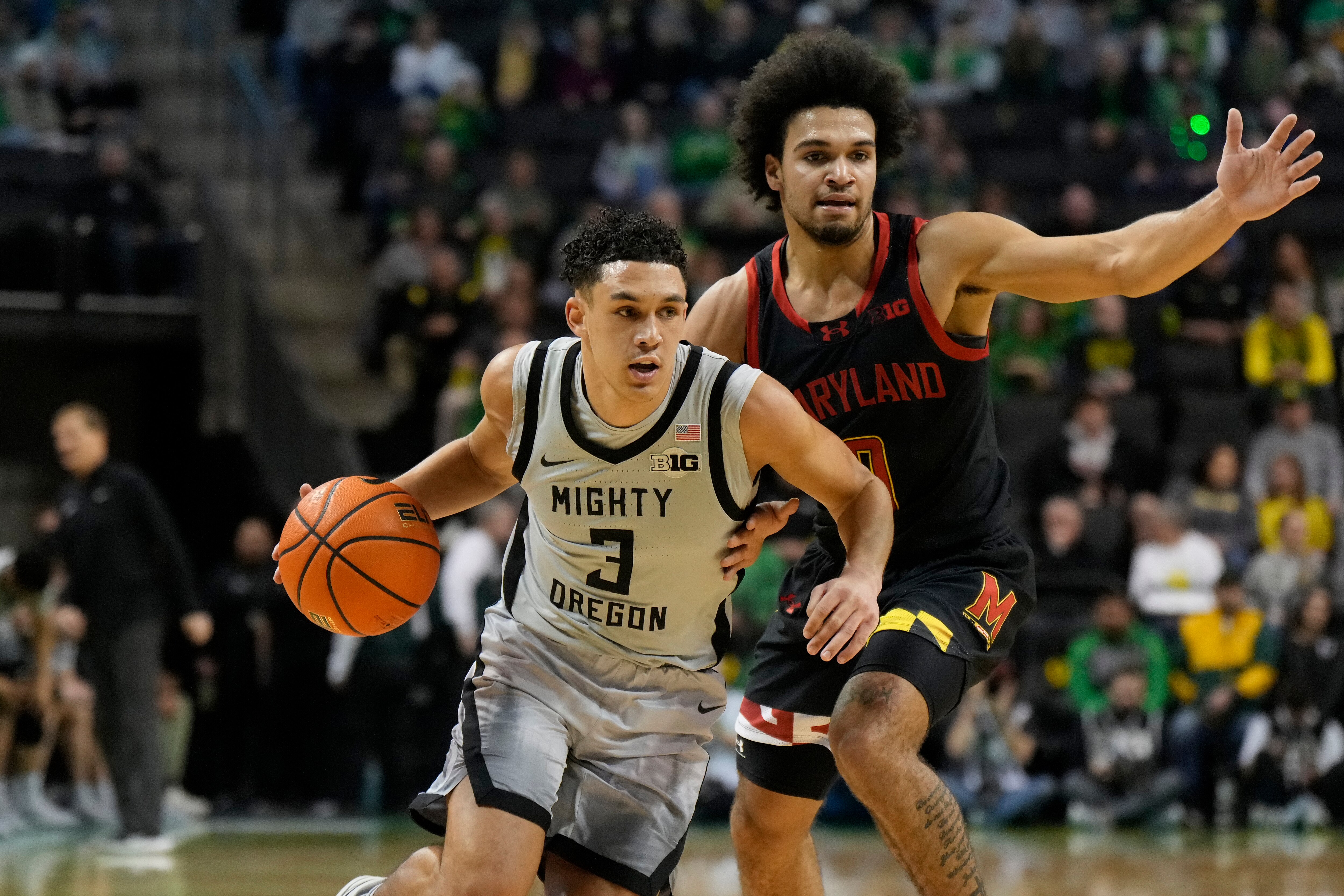 Jackson Shelstad of Oregon dribbles past Ja’Kobi Gillespie of Maryland during the first half Sunday.