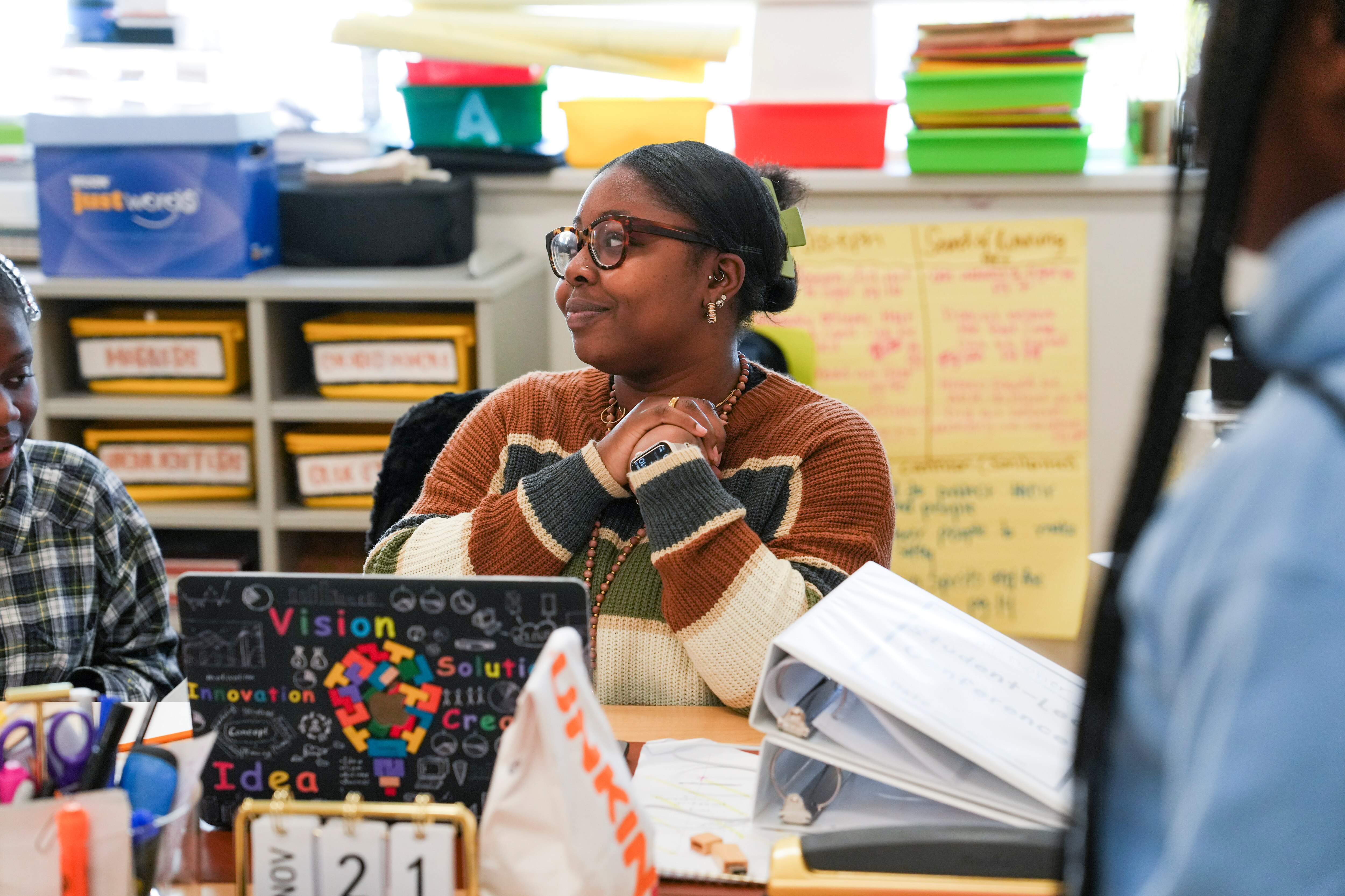 Haleemat Adekoya, fifth grade English and Language Arts teacher at Cherry Hill Elementary and Middle School, is a Sherman Scholar.  Here she helps students individually with their assignments.