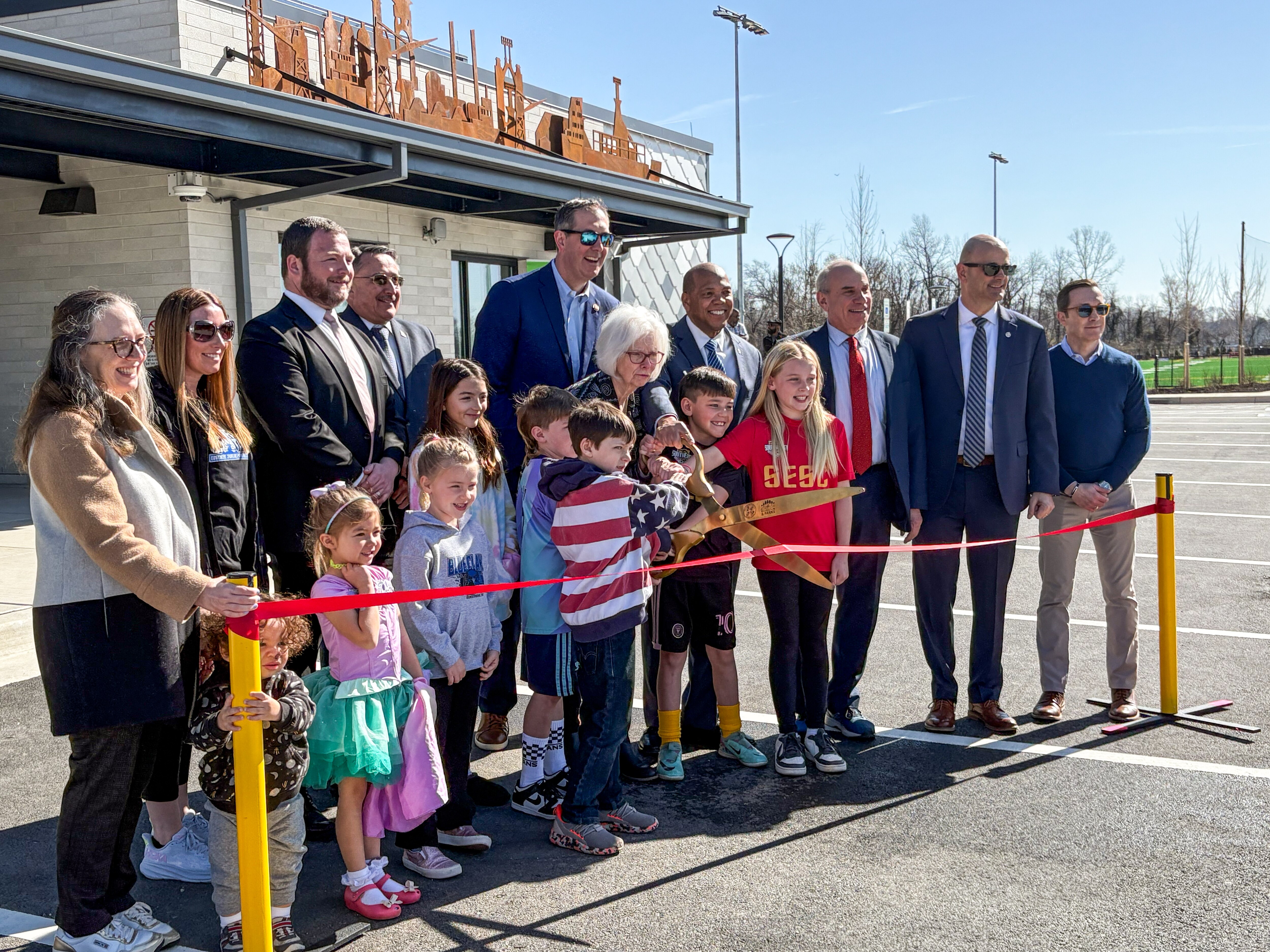County Executive Kathy Klausmeier, center, cuts the ribbon alongside local dignitaries and children at Sparrows Point Park on Wednesday.