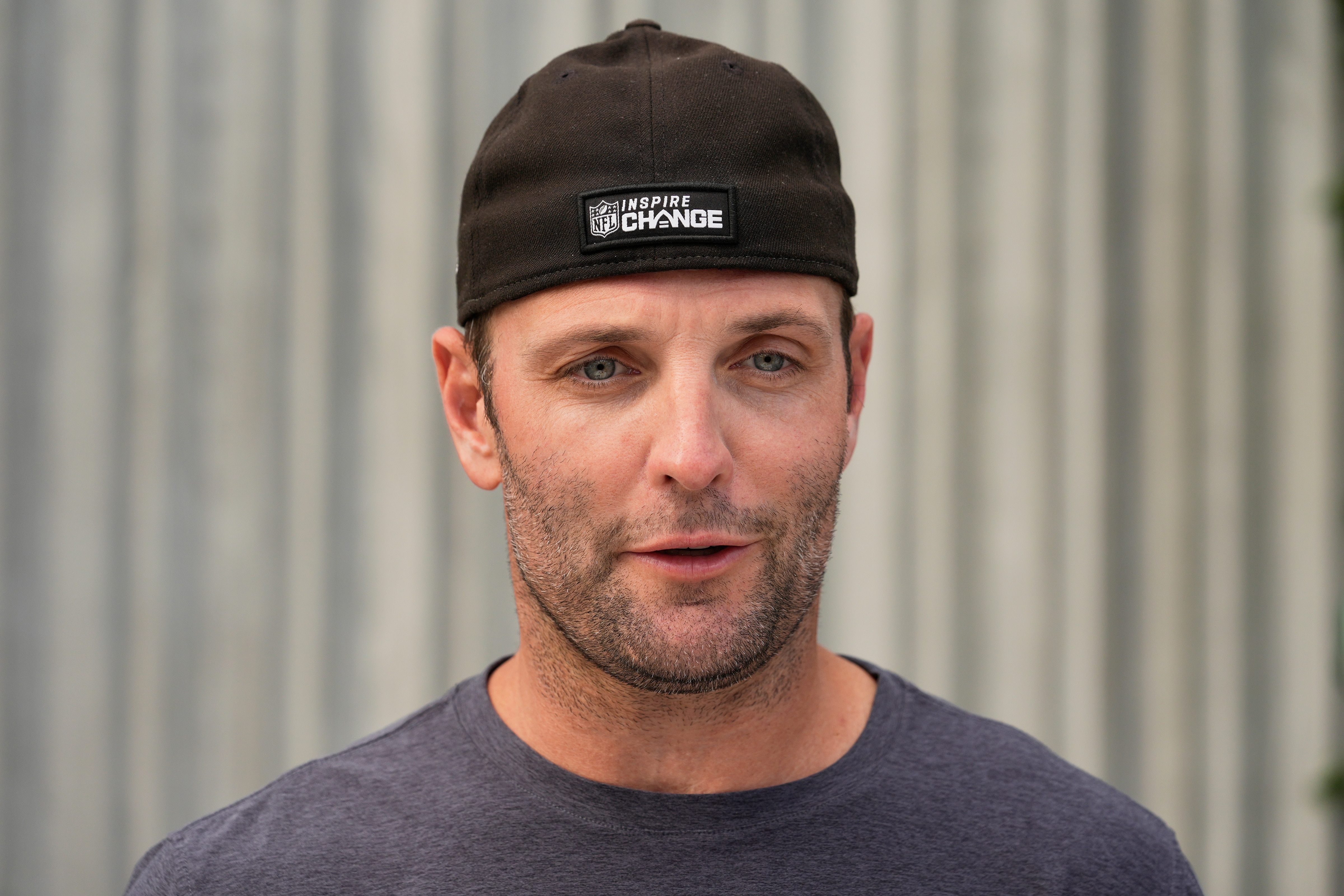 Wes Welker, picutred as the Miami Dolphins wide receivers coach, speaks after practice in June 2024.