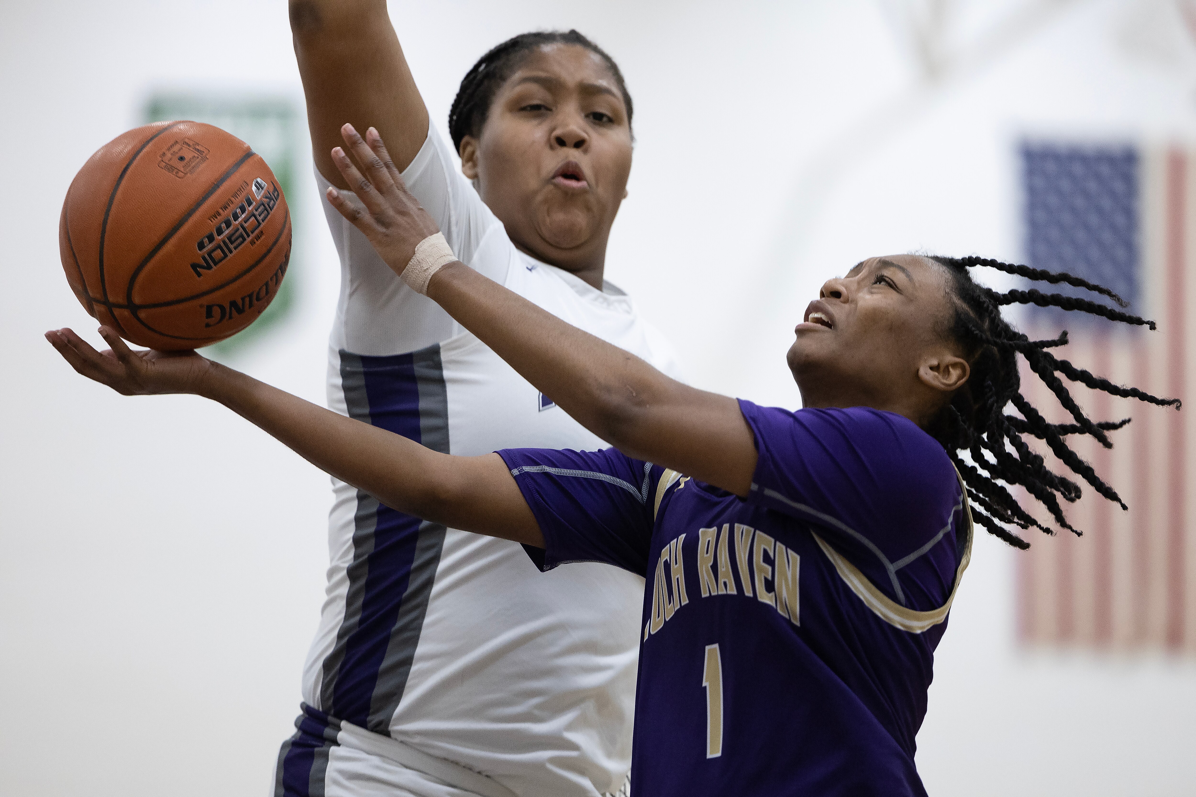 Pikesville's Tykeisha Hill #33 blocks a layup attempt by Loch Raven's Aariyn Gibson #1 during a regular season game between Loch Raven and Pikesville High School in Pikesville, Md., February 10, 2023. Pikesville defeated Loch Raven 57-29 in regulation time.