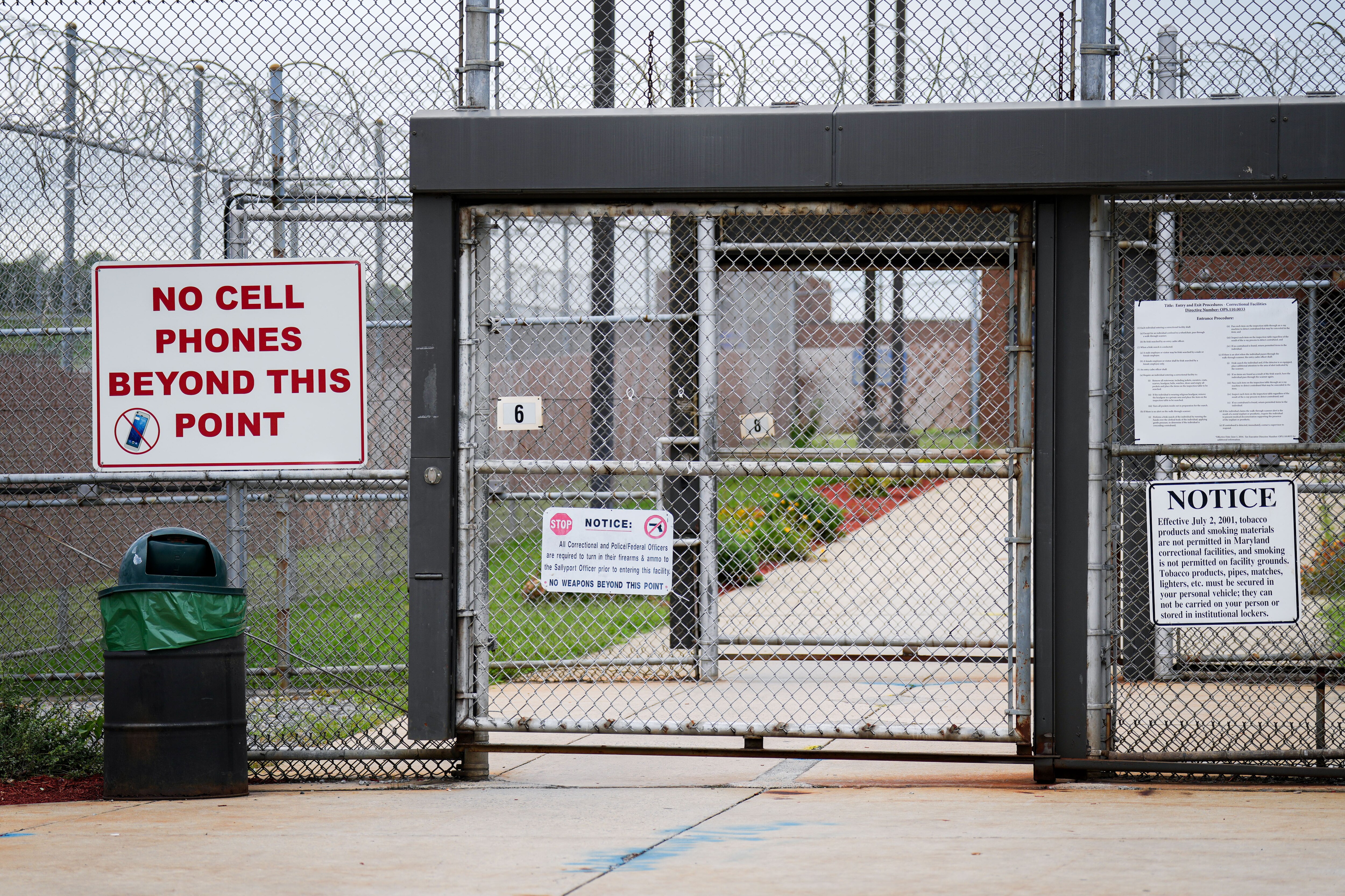 Barbed wire and visitor instructions are seen outside a Maryland correctional institution in August, 2024.