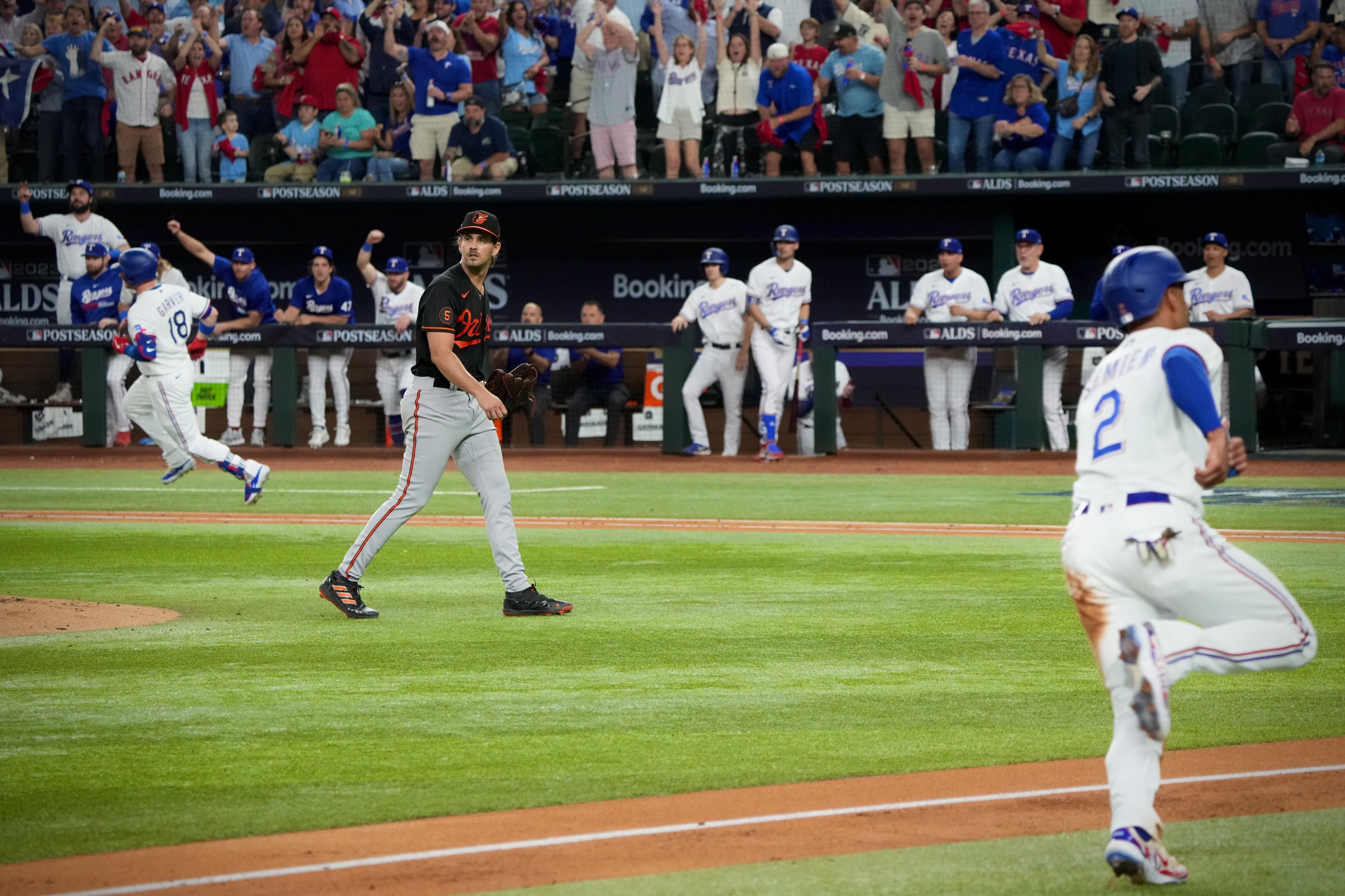 Orioles pitcher Dean Kremer looks on as Texas Rangers infielder Marcus Semien scores in the second inning of Game 3.