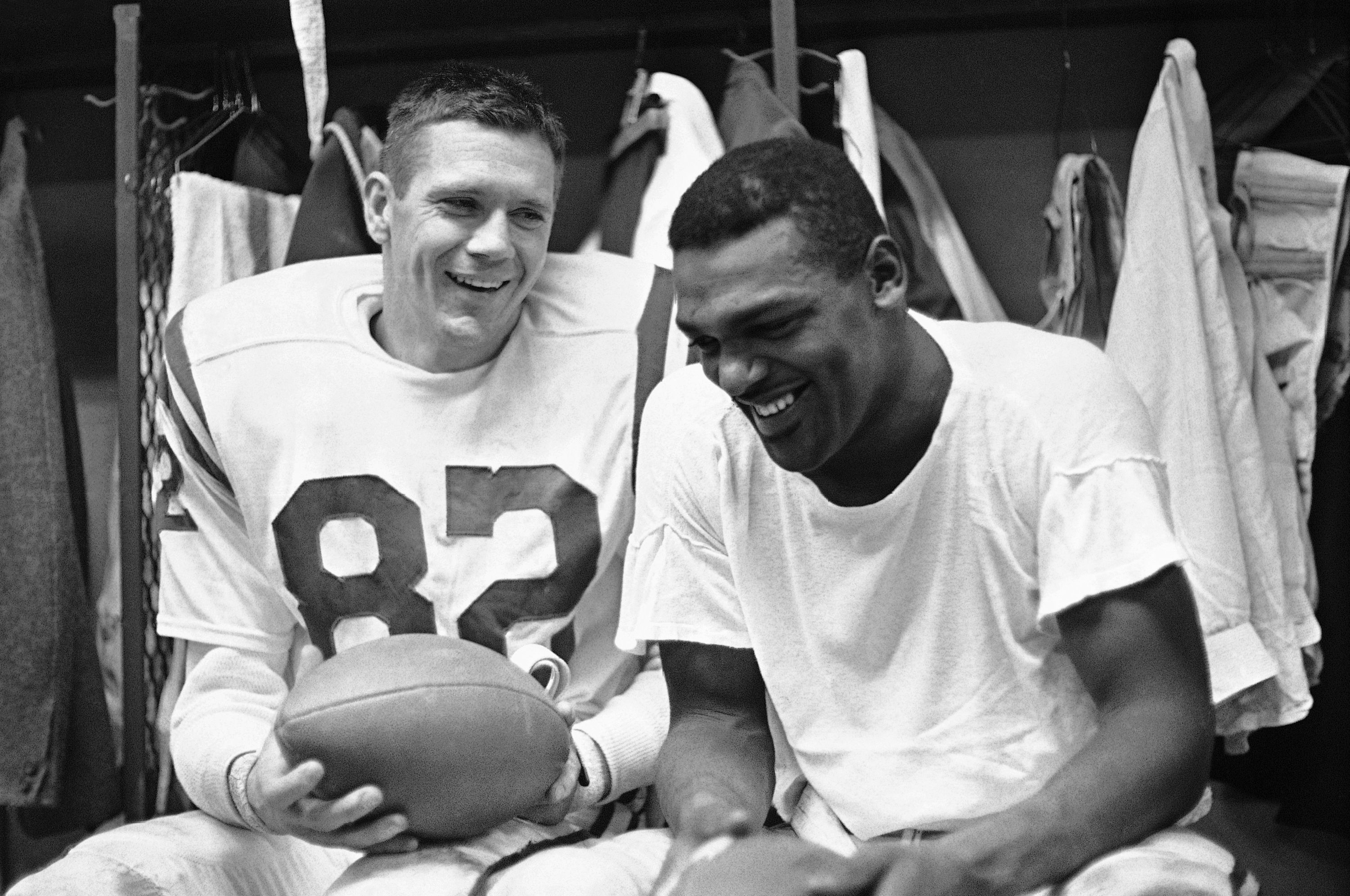 Baltimore Colts end Raymond Berry, left, and halfback Lenny Moore smile in the locker room in 1964.
