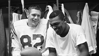 Baltimore Colts end Raymond Berry, left, and halfback Lenny Moore smile in the locker room in 1964.