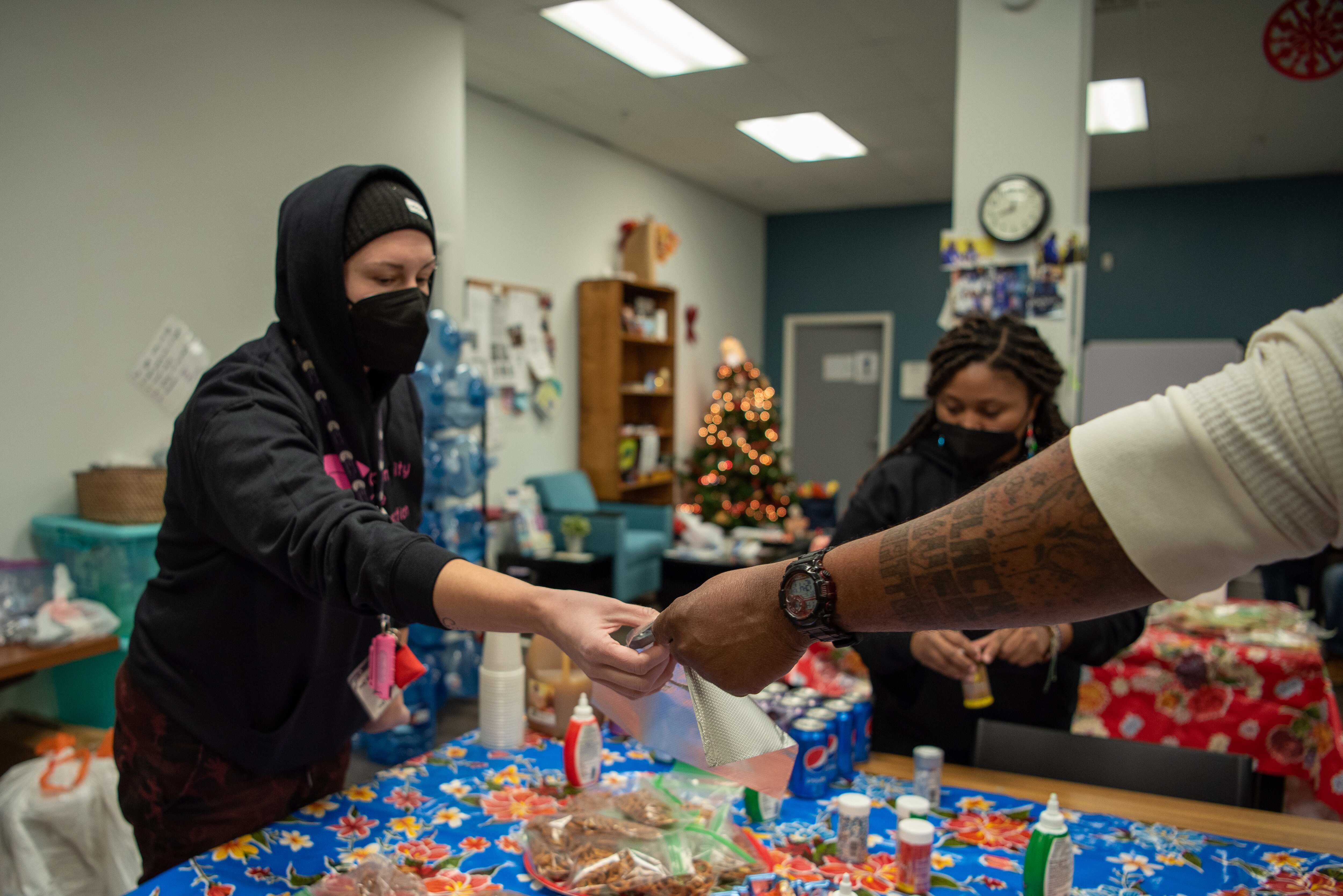 Employees and clients of Charm City Care Connection create edible holiday wreathes together using icing, sprinkles, and pretzels during the Holiday Party on Thursday December 22, 2022. 