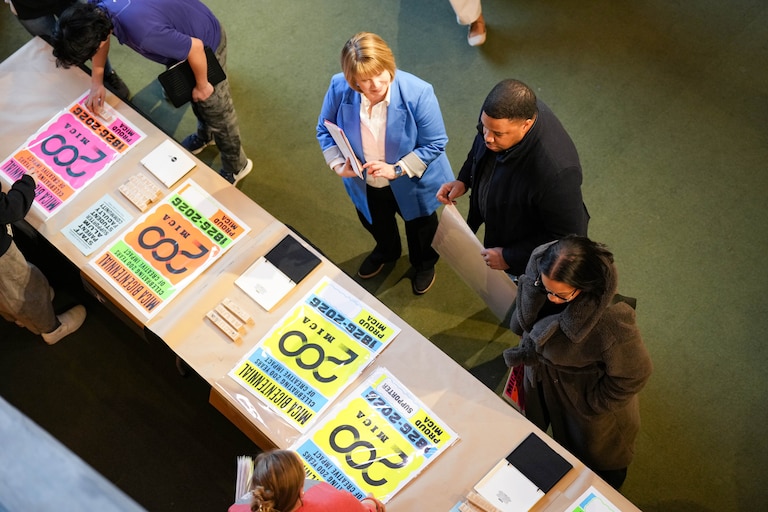 Baltimore City Councilman James Torrence, center, as well as other attendees examine commemorative posters during MICA’s bicentennial anniversary celebration at Falvey Hall on MICA’s campus in Baltimore, Md., on Wednesday, January 21, 2026.