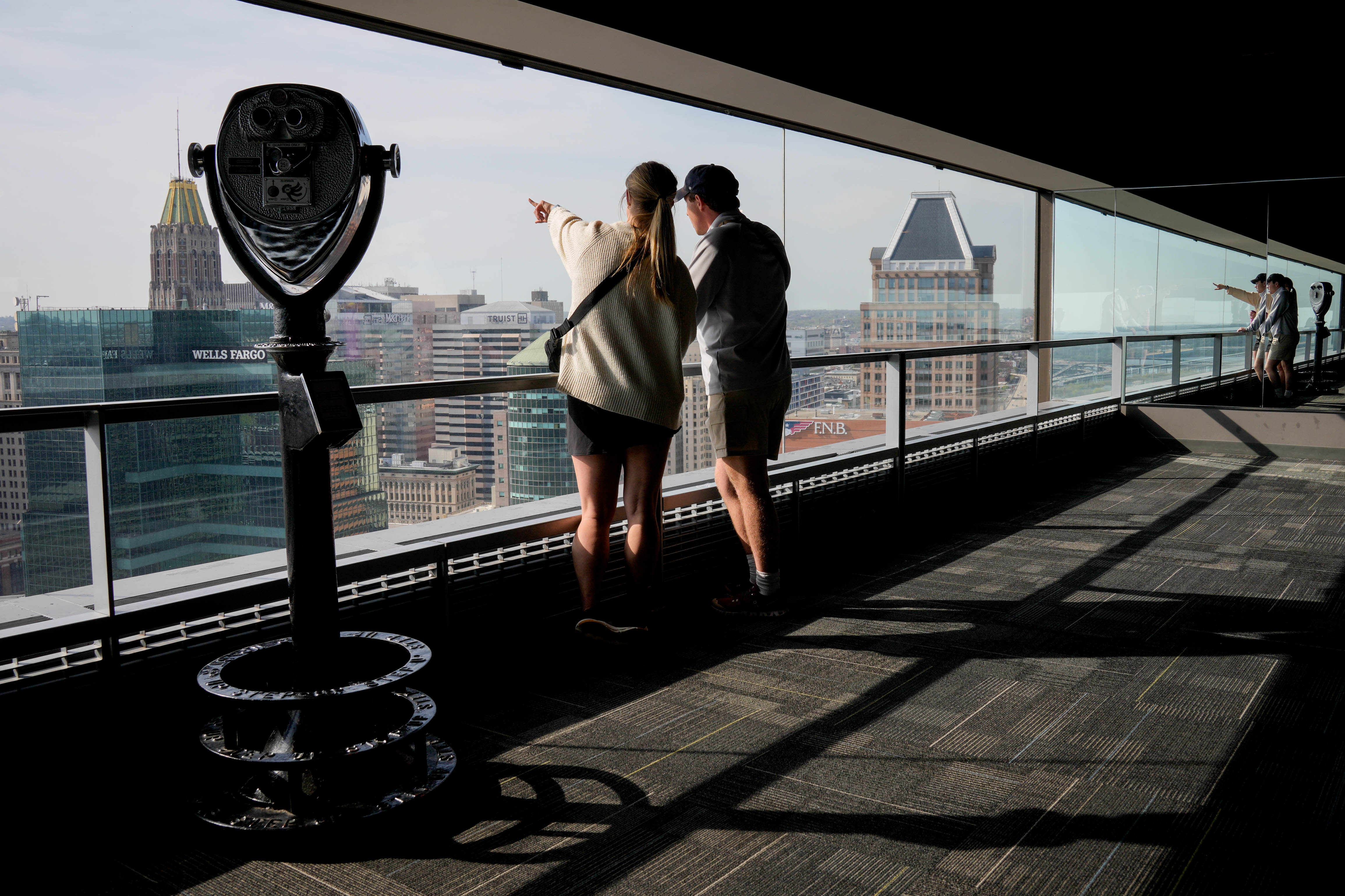 Hailey Midgley, left, and Brett Midgley check out the view from the Top of the World Observation Leck at the Baltimore World Trade Center in April.