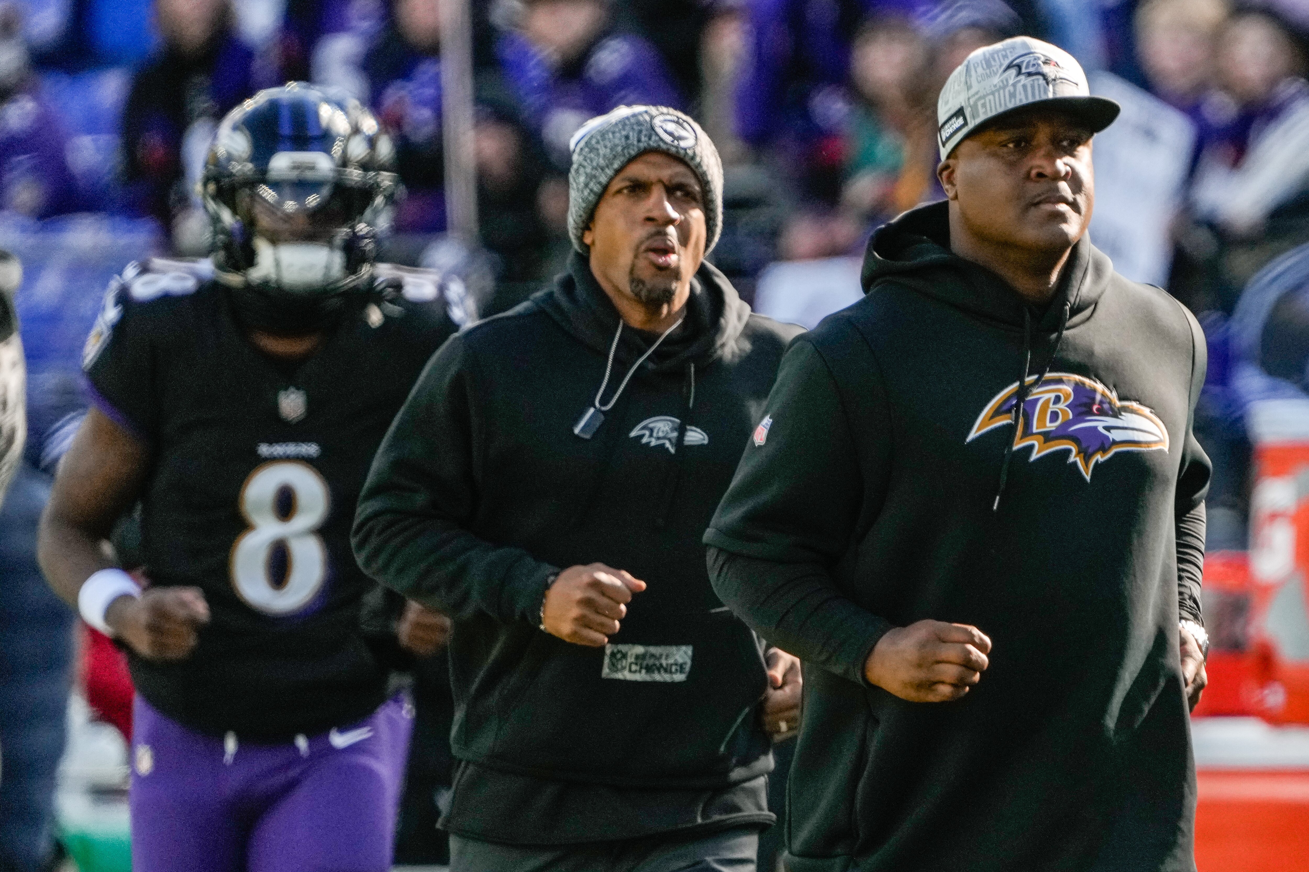 Ravens quarterbacks coach Tee Martin (right), assistant quarterbacks coach Kerry Dixon (center) and quarterback Lamar Jackson take the field for warmups before the Dec. 31 against the Miami Dolphins.