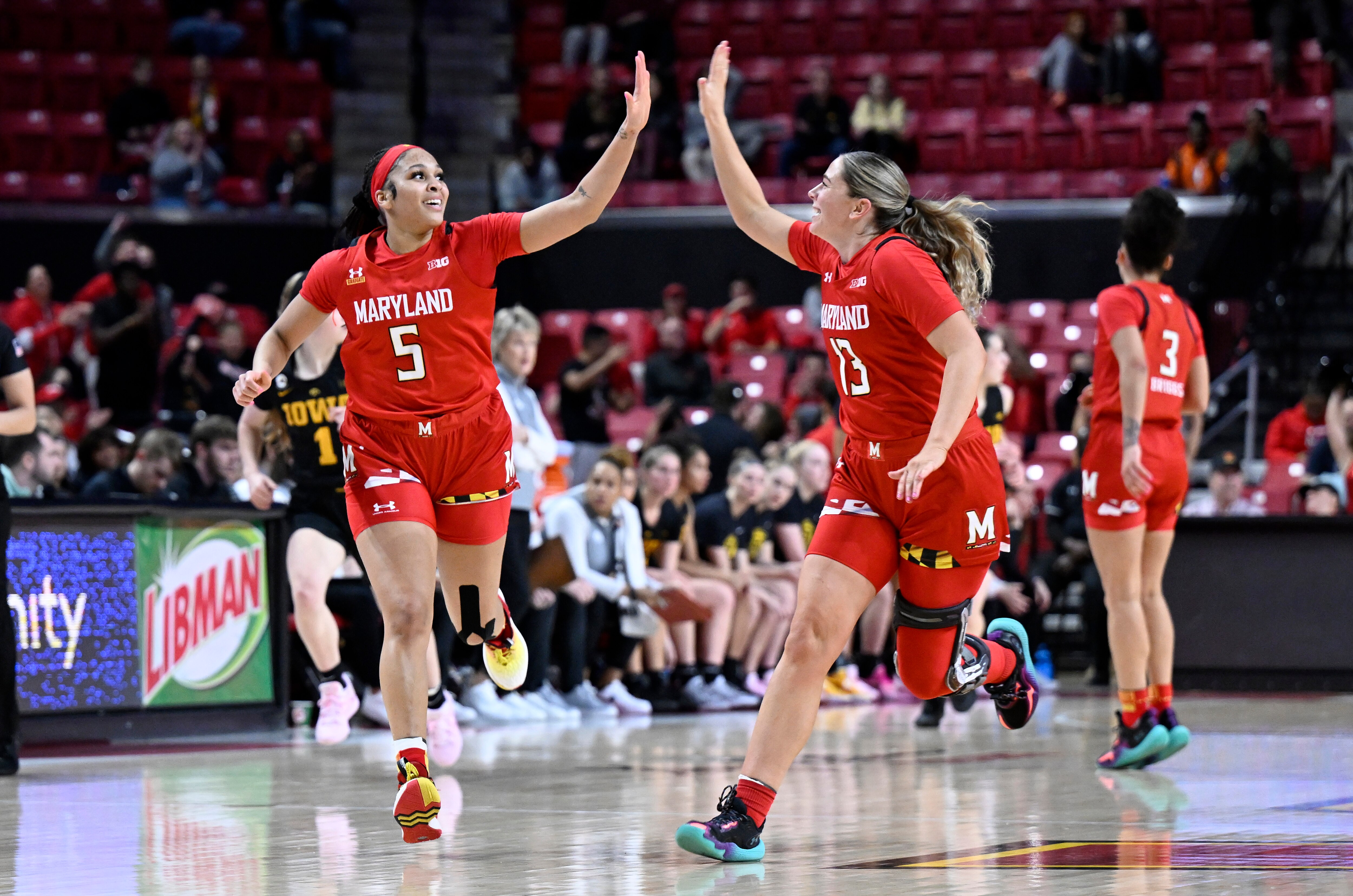 COLLEGE PARK, MARYLAND - FEBRUARY 21: Brinae Alexander #5 and Faith Masonius #13 of the Maryland Terrapins celebrate in the second quarter of the game against the Iowa Hawkeyes at Xfinity Center on February 21, 2023 in College Park, Maryland.