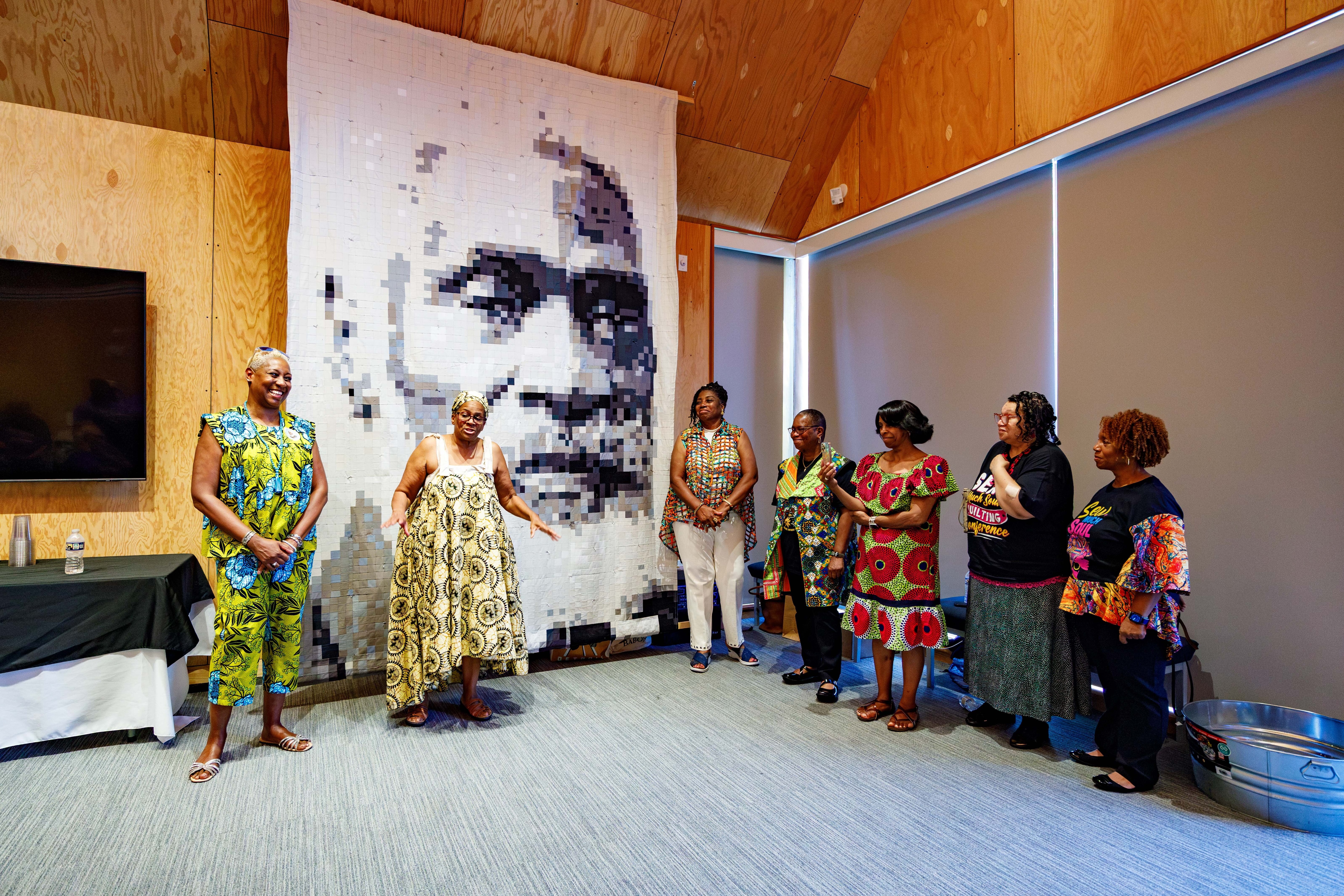 Several of the quilt makers, including Tisha Thorne, left, gather in front of their creation at the quilt’s unveiling Saturday at the Josiah Henson Museum and Park.