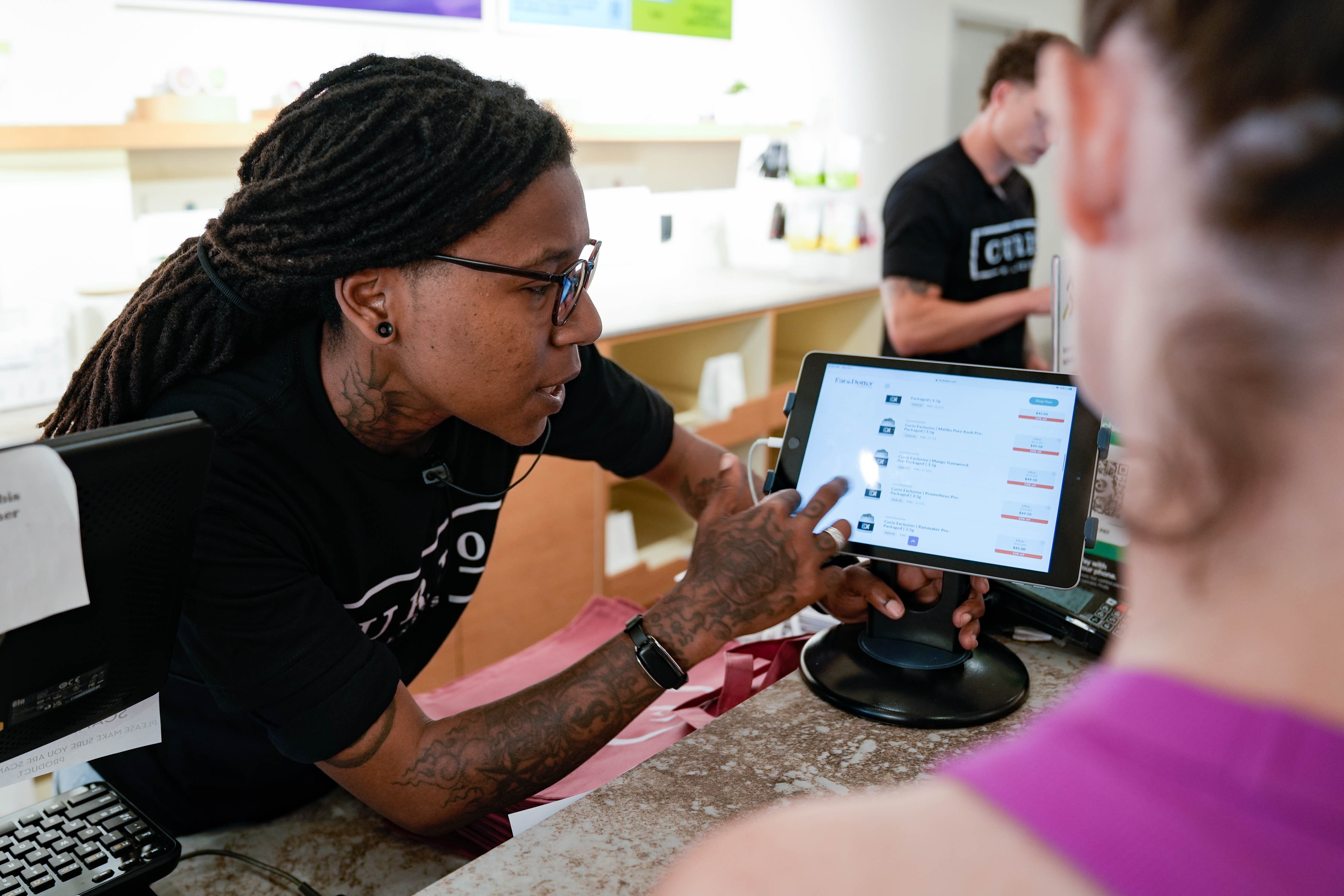 Megan Pullins helps a customer at Far & Dotter on July 1, 2023, the first day of recreational cannabis legalization in Maryland.