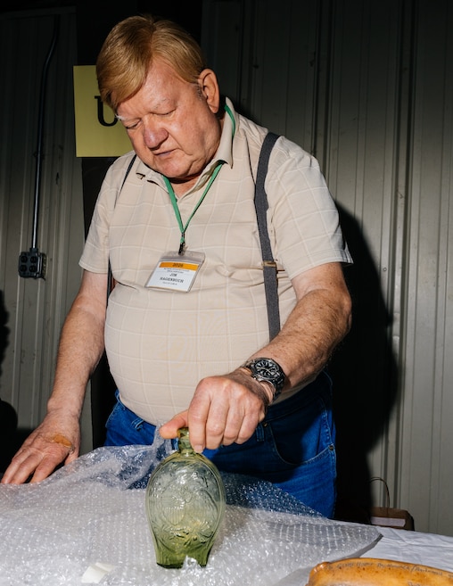 Jim Hagenbuch, owner of Glass-Works Auctions, unveils a rare historical flask which he expects to auction somewhere between $60-90k at The Baltimore Antique Bottle Club 45th Annual Show & Sale at the Howard County Fair Grounds.
