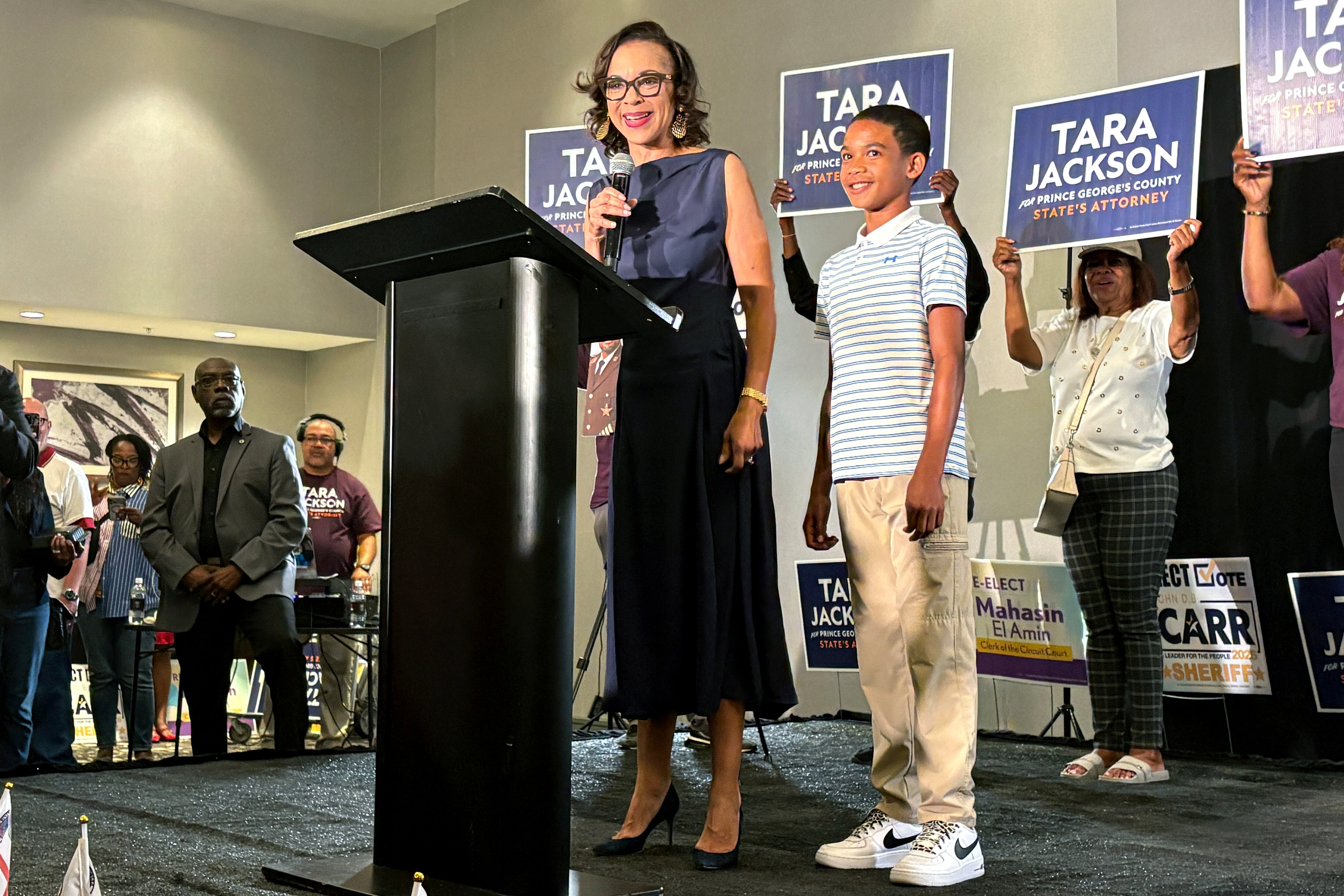 Tara Jackson stands with her son as she addresses supporters in Largo on Election Day.