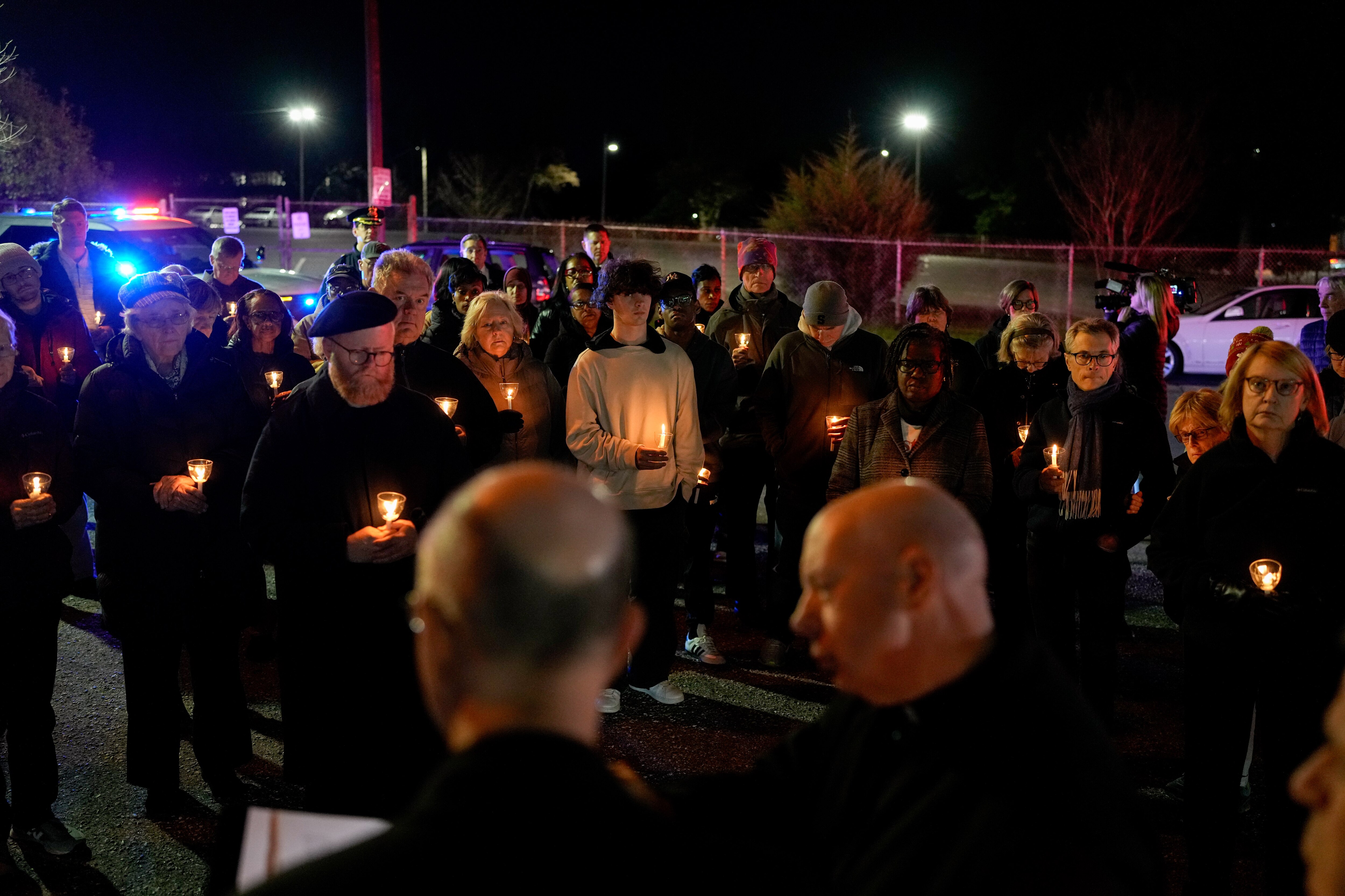 Parishioners hold candles during a prayer walk in the Irvington neighborhood of Baltimore, Md. on Monday, December 30, 2024.