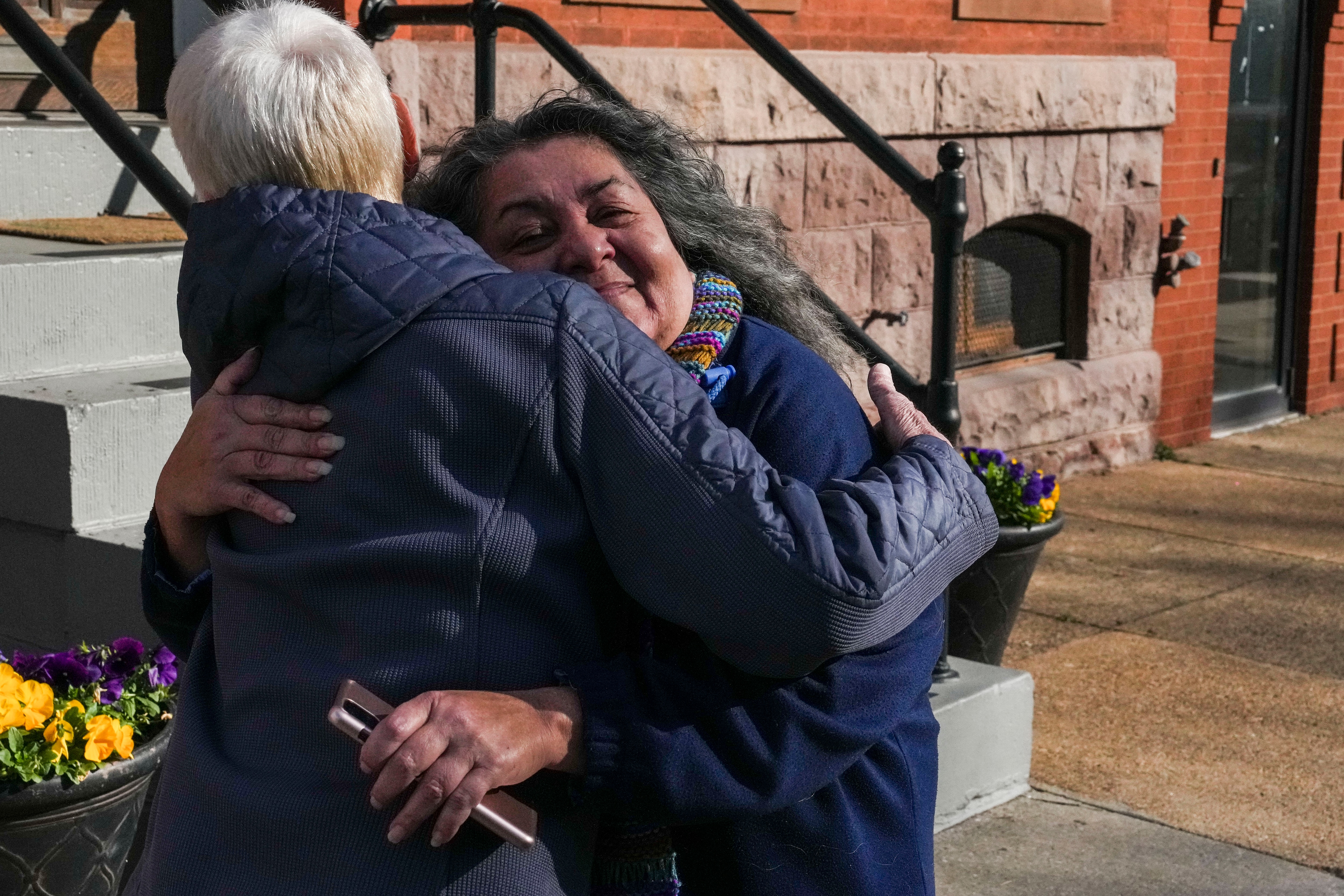 Liz Murphy and Linda Malat Tiburzi (right) embrace outside of Our Lady of Good Counsel School and church on Fort Avenue in South Baltimore in January 2023. Their friendship spanned decades. Tiburzi, who dedicated her life to supporting abuse survivors, died Tuesday, Oct. 17, 2023, at age 62.