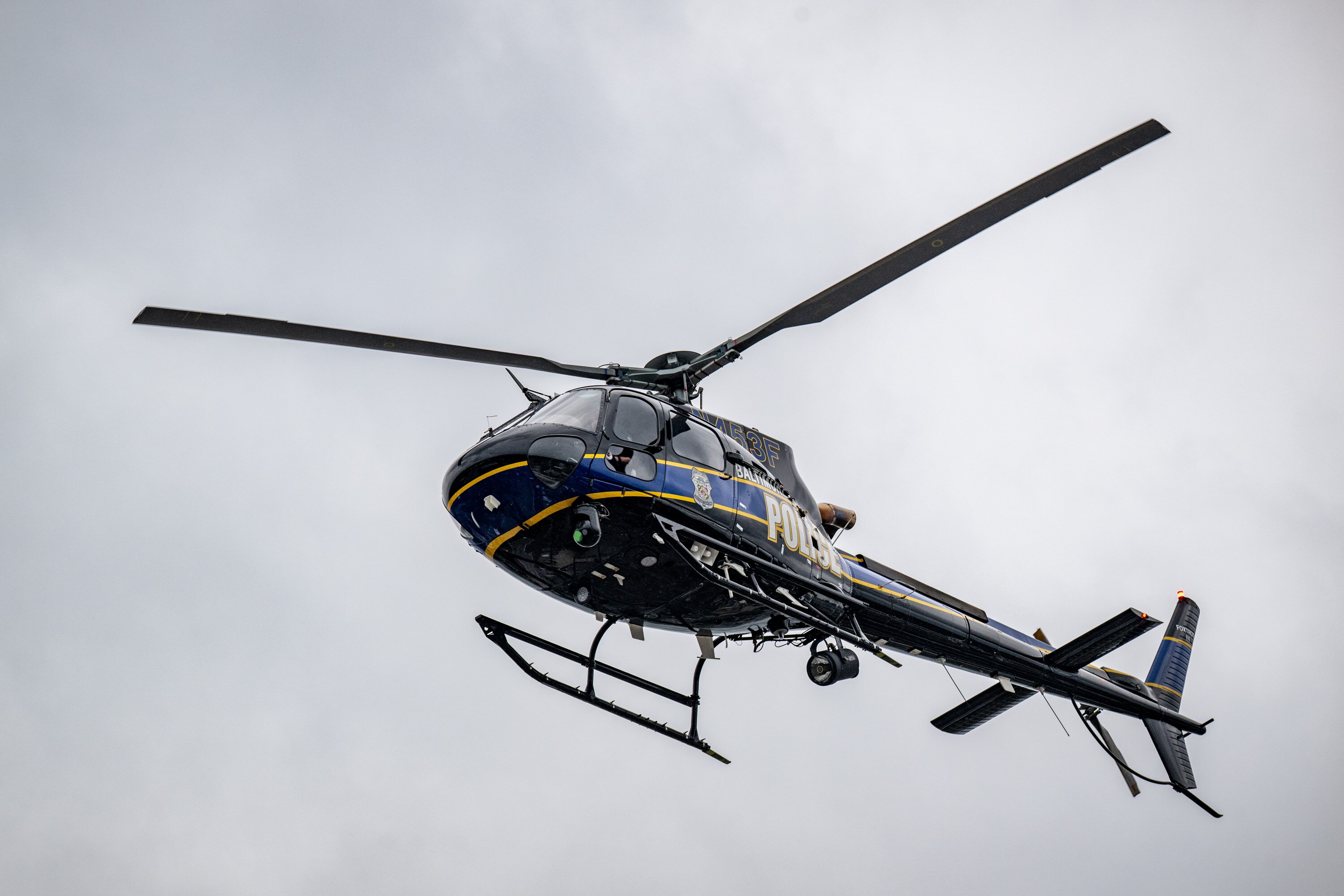 Baltimore Police helicopter Foxtrot flies low over the Penn North neighborhood looking for overdose victims following a mass overdose incident on Thursday, July 10, 2025.