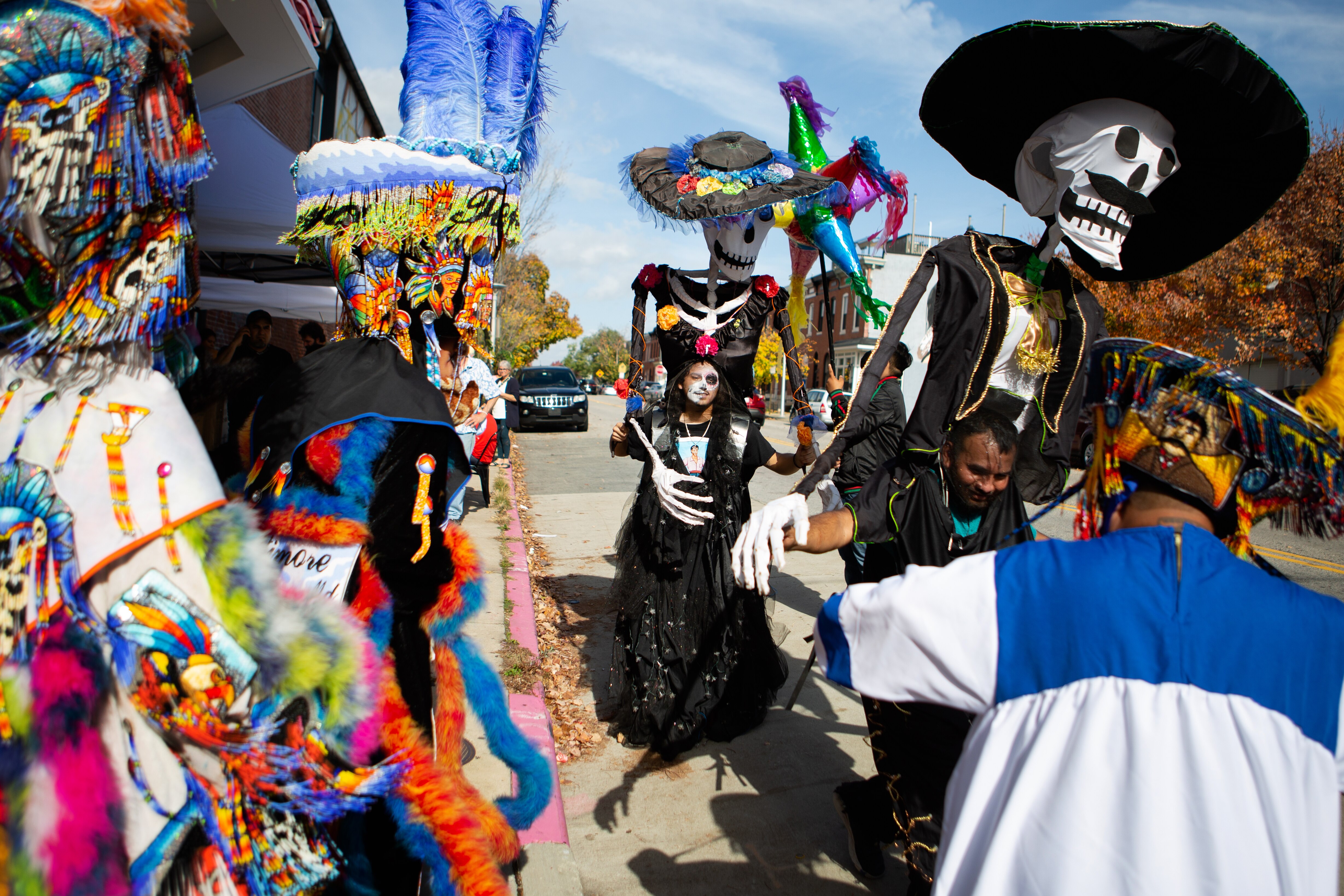 11/5/22 – El Catrín and La Catrina dance among traditional Chinelos dancers outside the Creative Alliance as part of the organization's Día de los Muertos celebration on Saturday. The event featured a parade around Patterson Park, live music, traditional art and food, and dance performances.